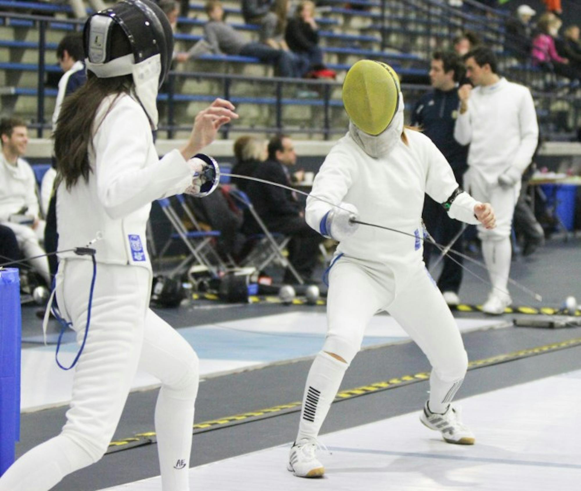 Irish senior epee Nicole Ameli, right, duels with an opponent Feb. 9 during the DeCicco Duals at the Castellan Family Fencing Center.