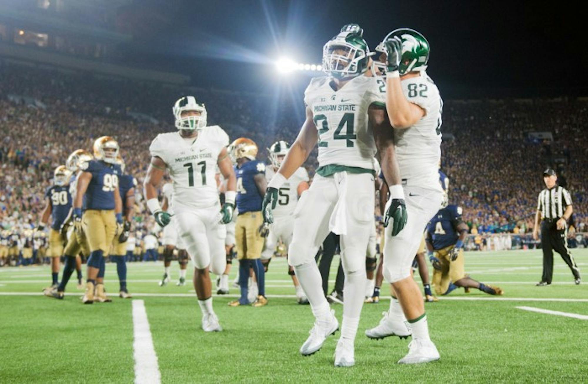 Michigan State players celebrate during Notre Dame's 36-28 loss to the Spartans on Saturday.