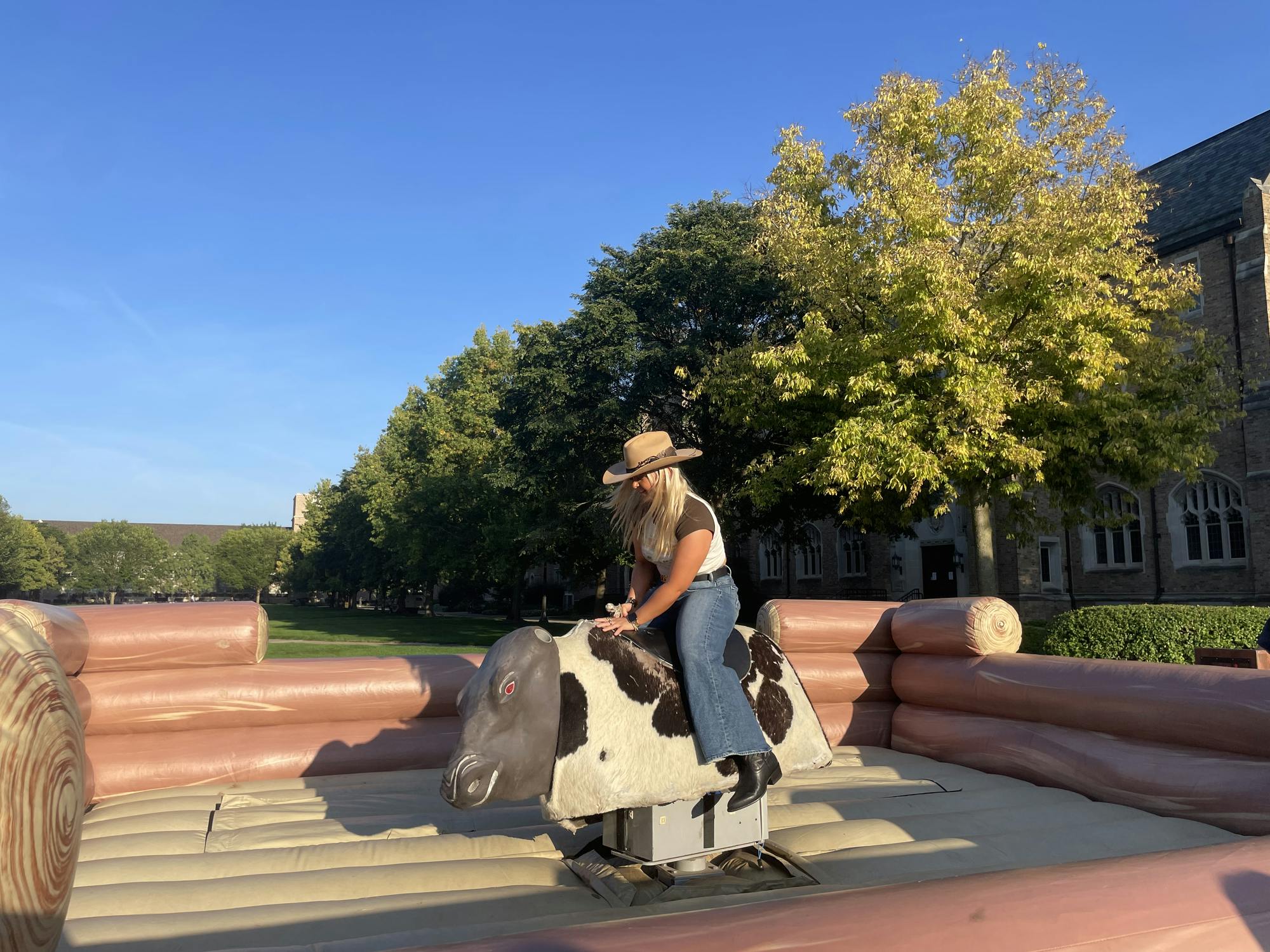 Students ride the mechanical bull for annual dorm signature event