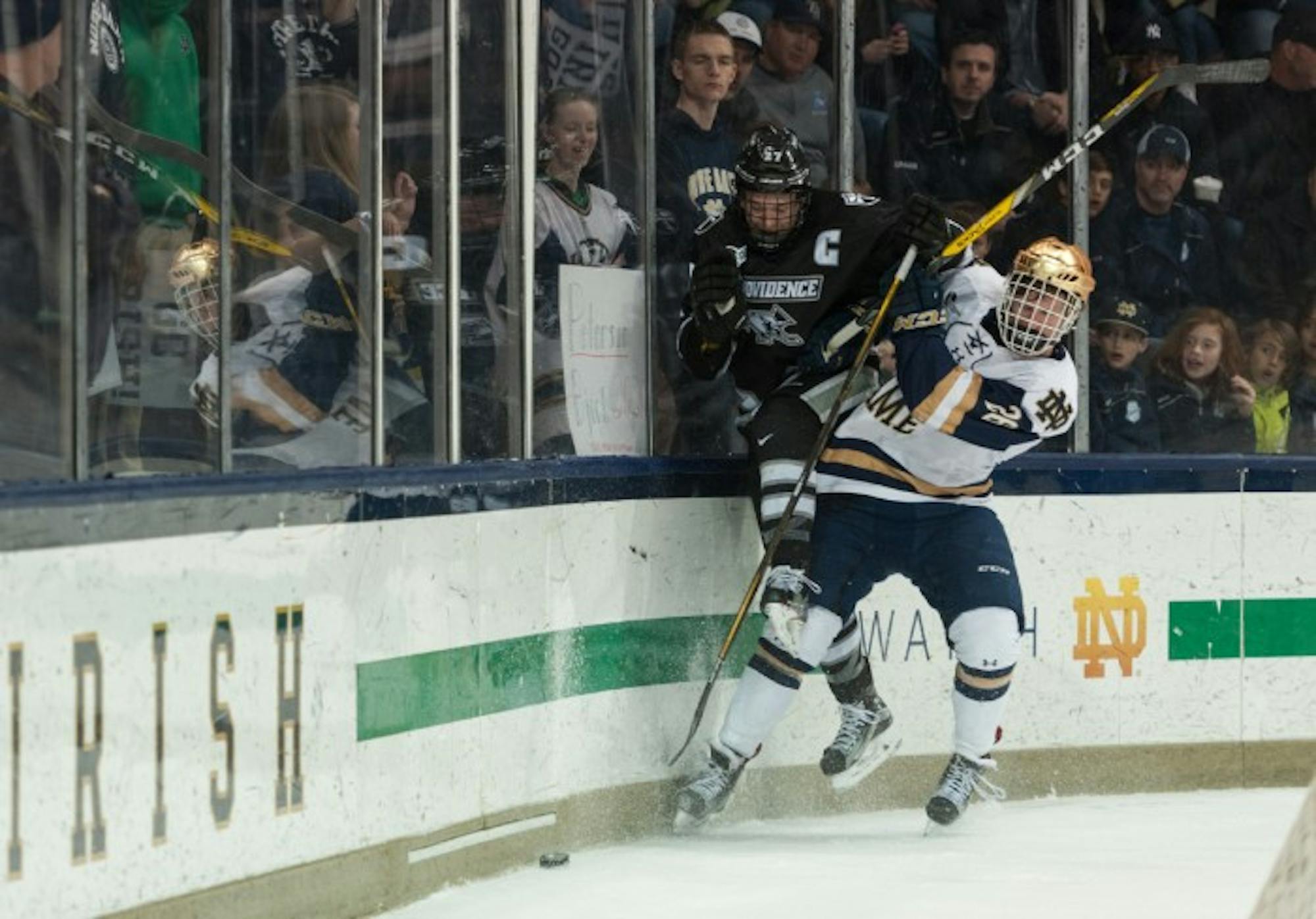 Irish freshman forward Cam Morrison fights for the puck during Notre Dame's 5-2 win over Providence on March 11 at Compton Family Ice Arena.
