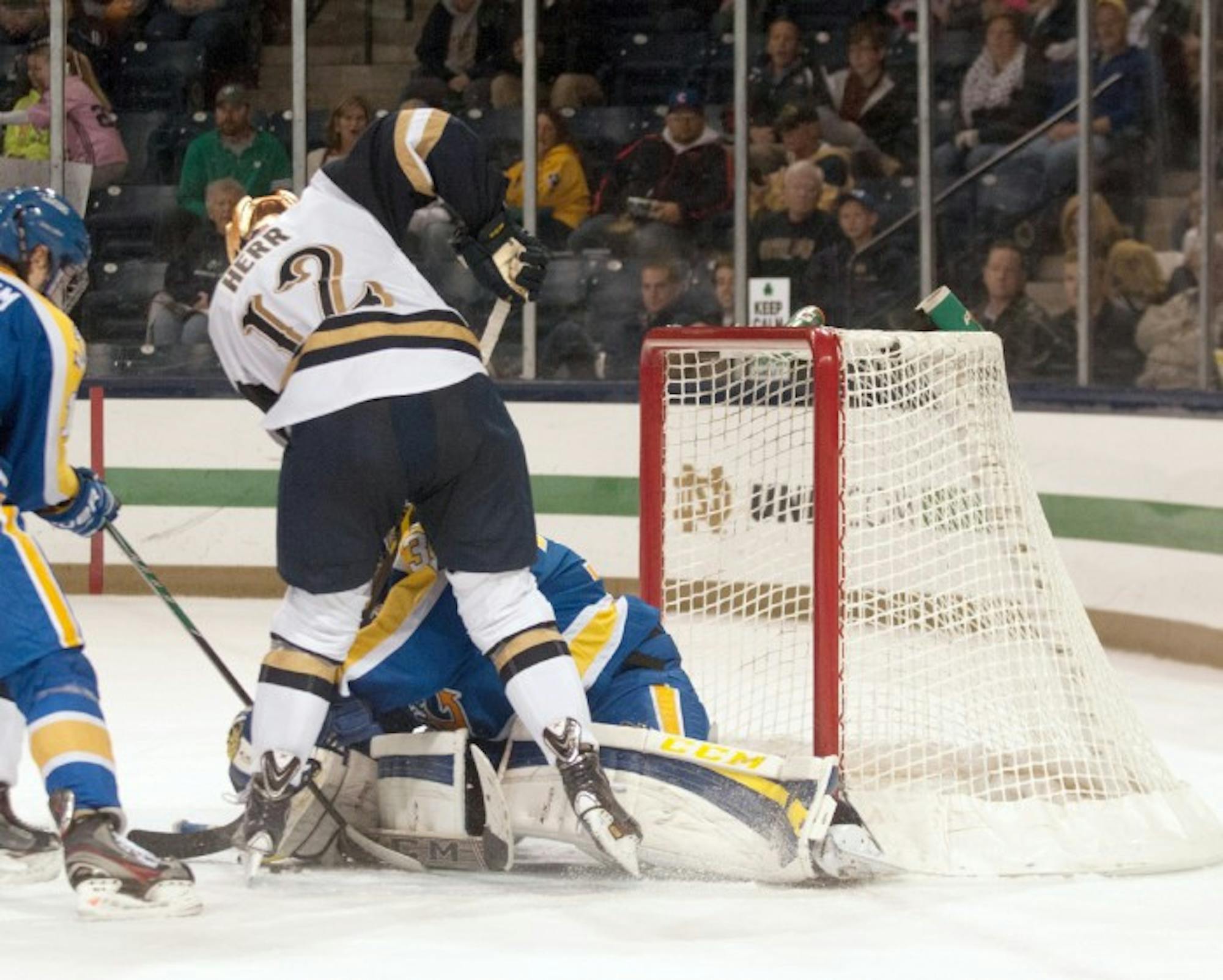 Irish junior left wing Sam Herr crashes the net against Lake Superior State on Oct. 17, at Compton Family Ice Arena. Herr has three goals on the season while junior left wing Mario Lucia leads the team with six.