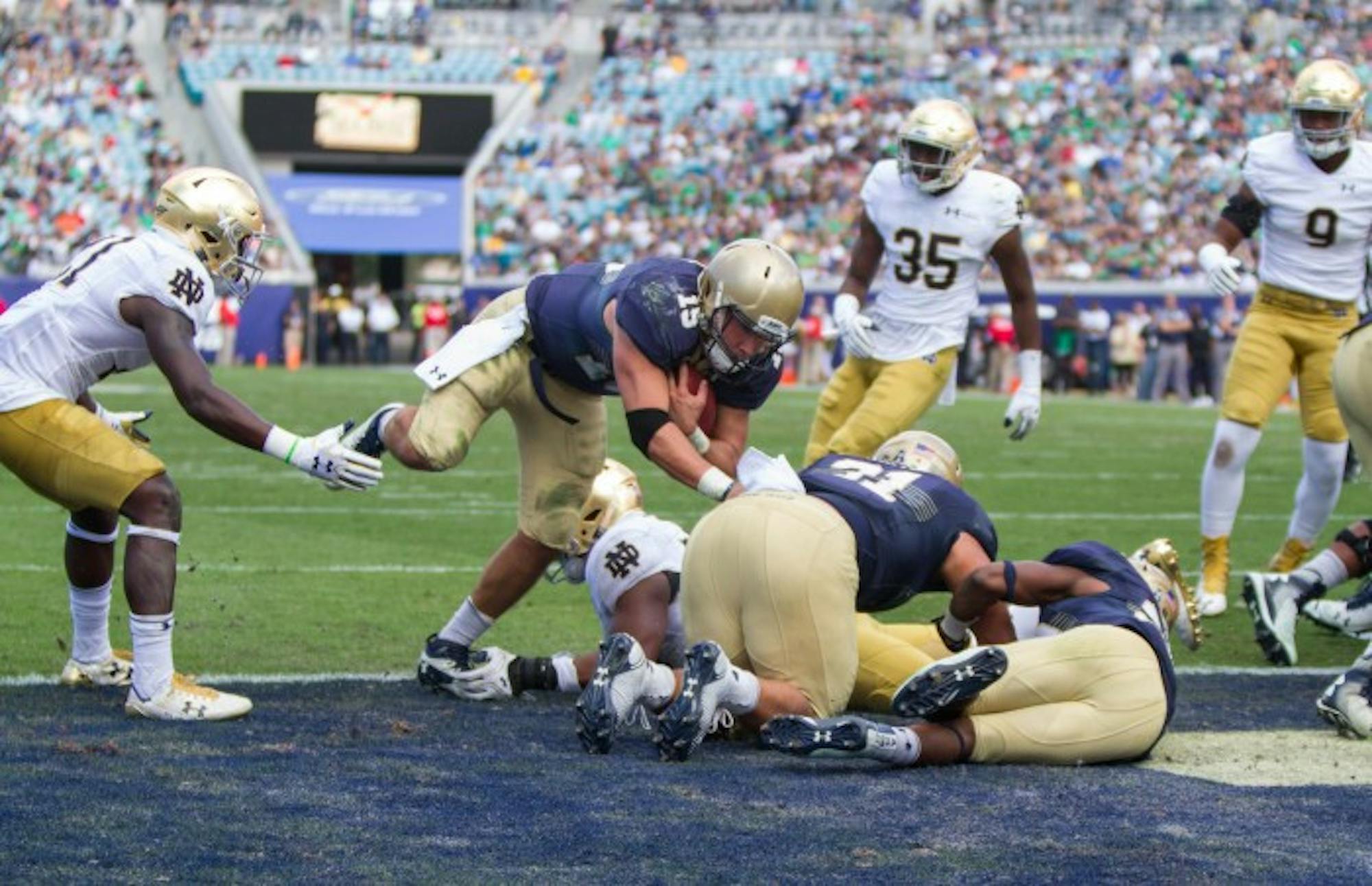Quarterback Will Worth punches through Notre Dame defense to score the touchdown that would eventually secure the Navy victory.