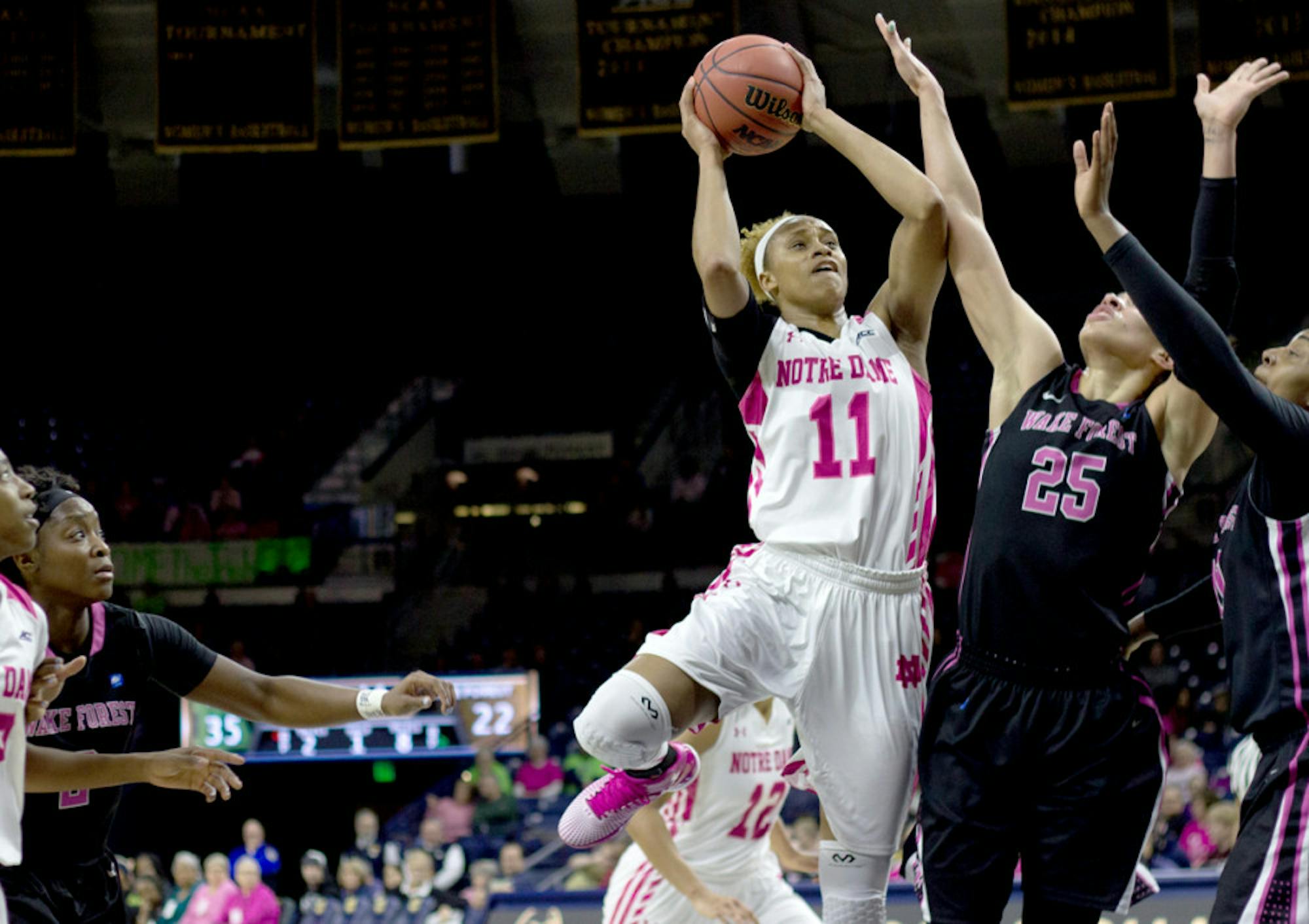 Notre Dame freshman forward Brianna Turner leaps to fire a contested shot over Wake Forest senior forward Dearica Hamby during a 92-63 Irish home victory over the Demon Deacons on Feb. 1.