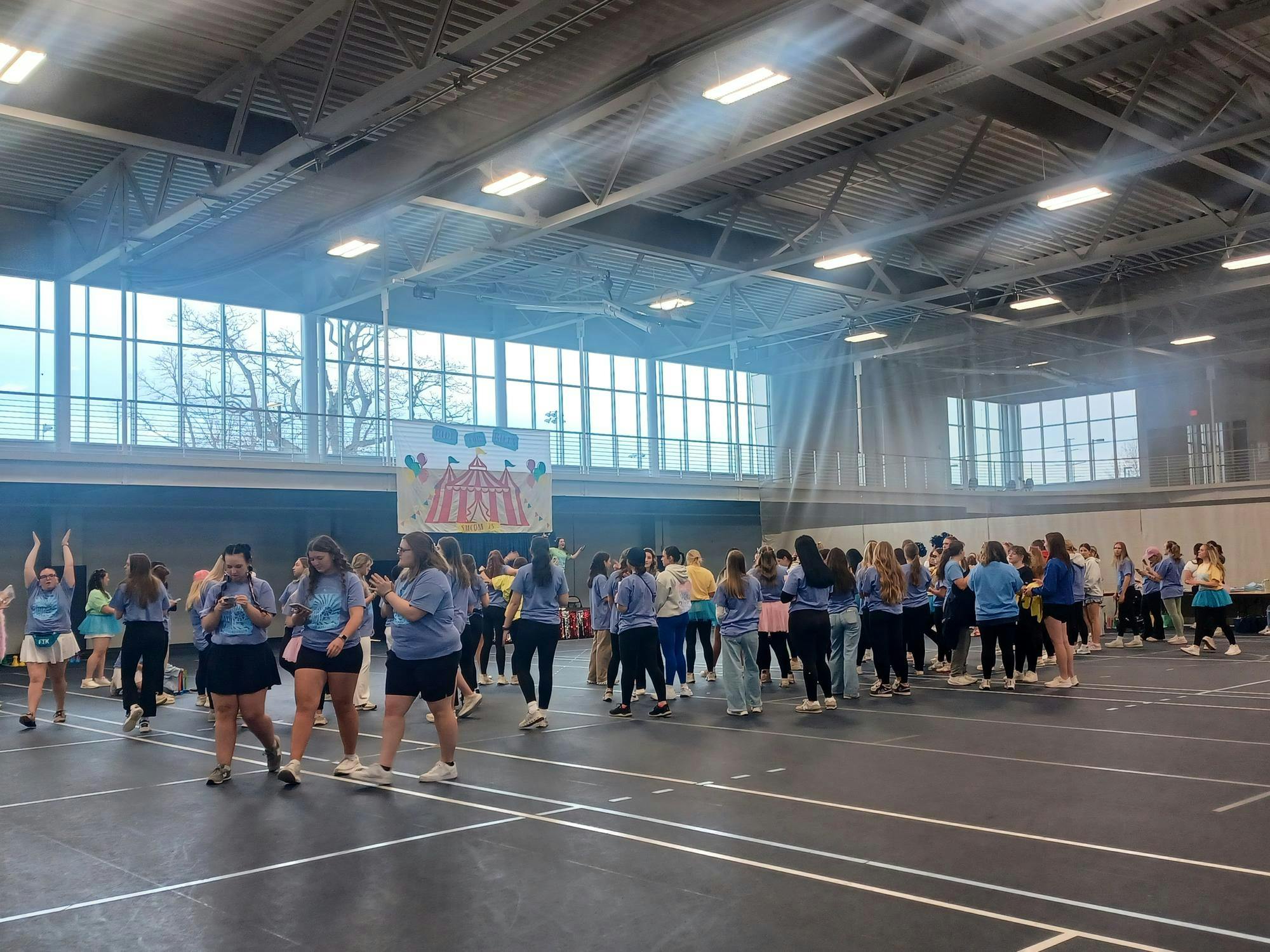 Attendees assemble at the fieldhouse of the Angela Athletic and Wellness Complex