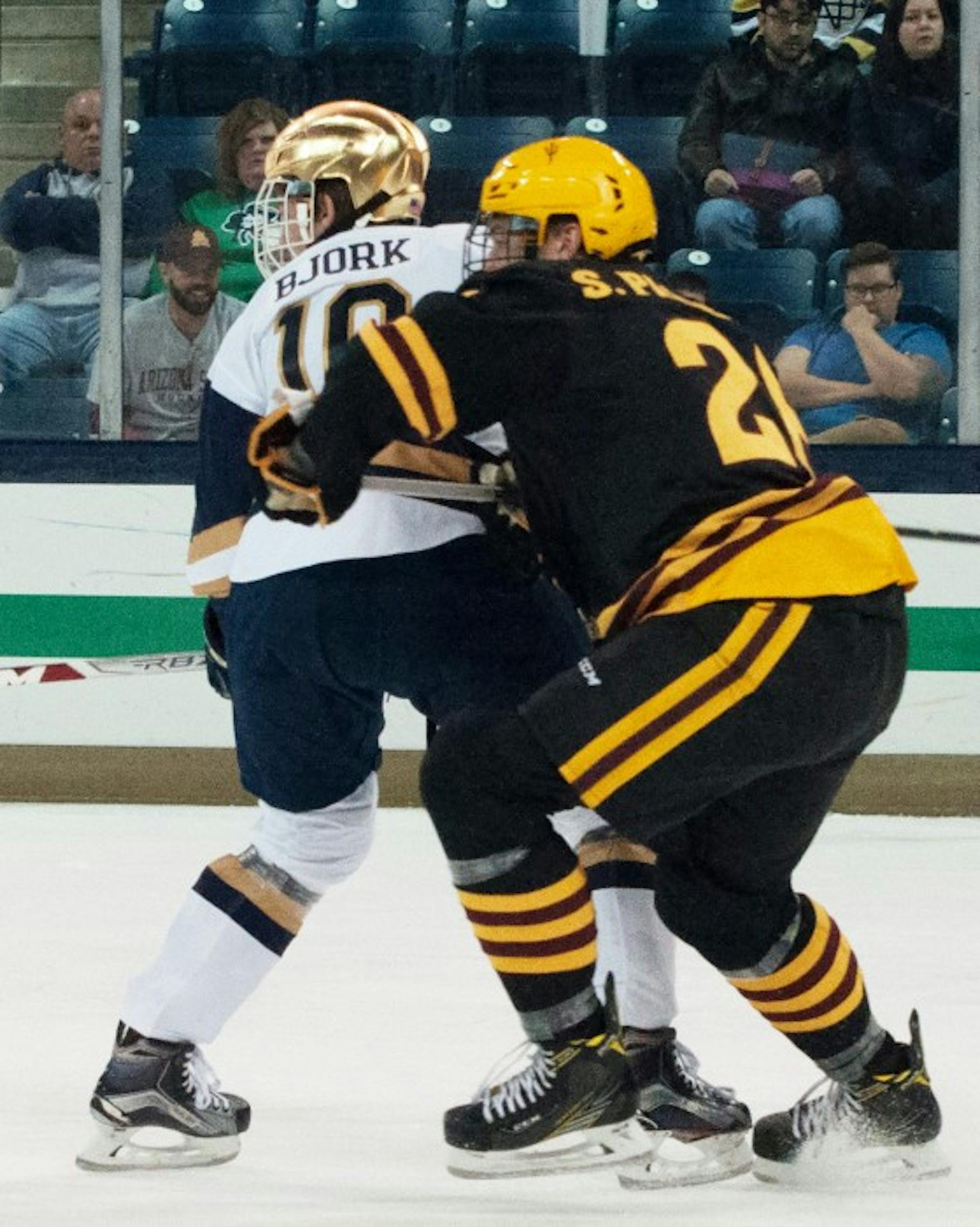 Junior forward Anders Bjork holds off a defender during Notre Dame’s 4-2 win over ASU on Saturday at Compton Family Ice Area.