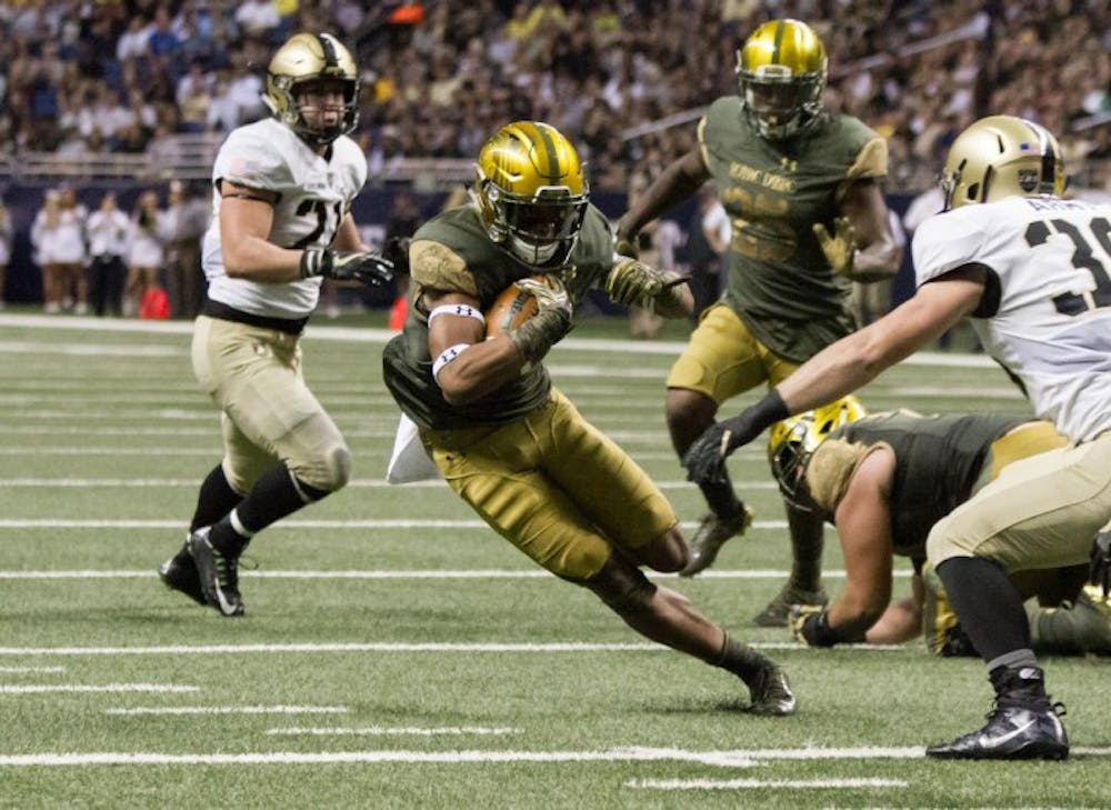 Senior running back Tarean Folston jukes an approaching defender during Notre Dame’s 44-6 win over Army on Nov. 12.