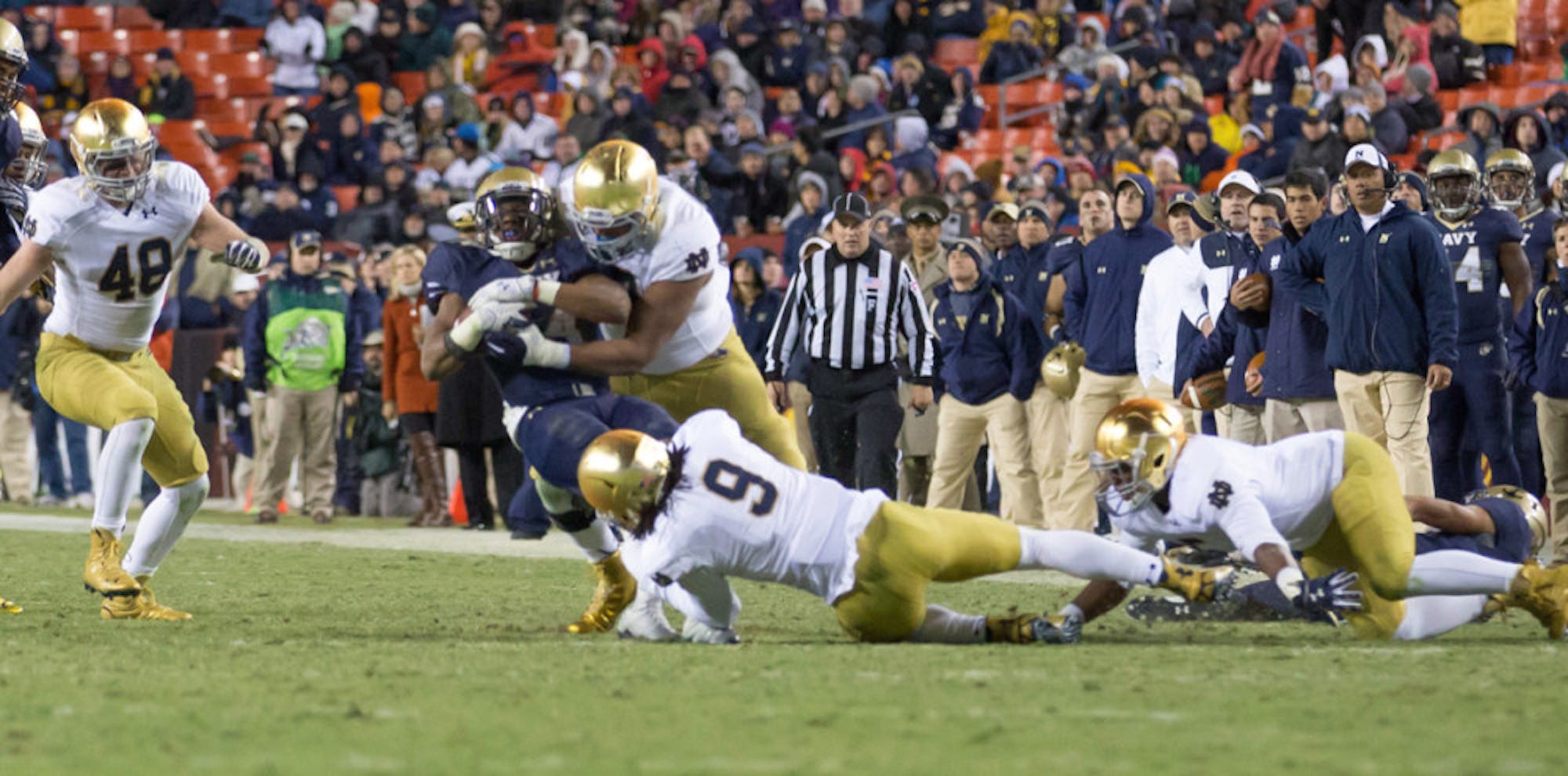 Irish sophomore defensive end Isaac Rochell and sophomore linebacker Jaylon Smith gang up to bring down a Navy ballcarrier during Notre Dame’s 49-39 win Saturday.
