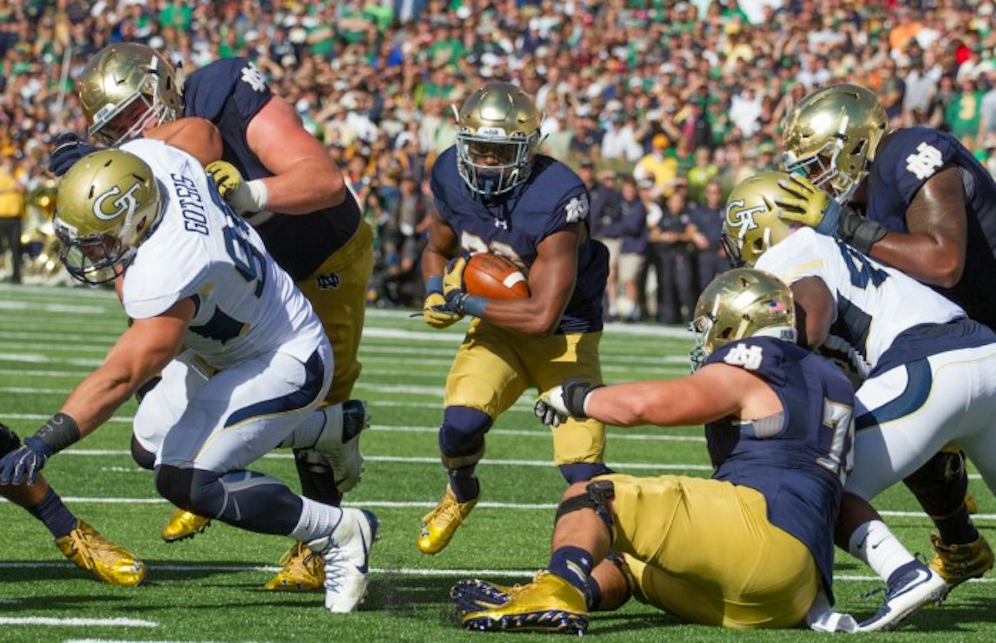 Senior running back C.J. Prosise runs through a hole in Notre Dame’s victory over Georgia Tech on Saturday on his way to 198 rushing yards.