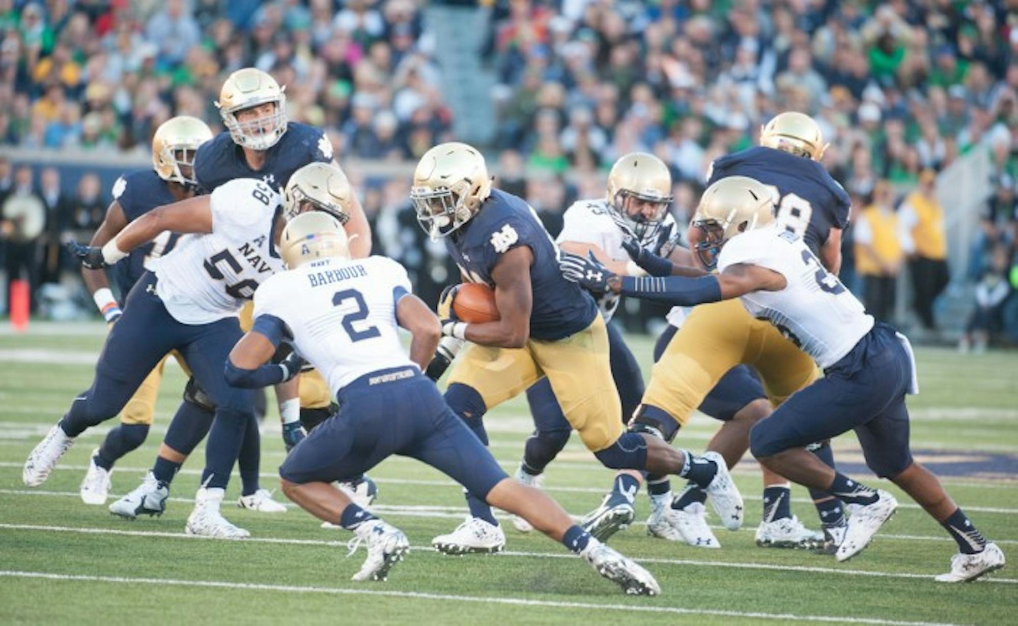 Irish senior running back C.J. Prosise finds a hole Saturday during Notre Dame’s 41-24 victory over Navy. Prosise carried the ball 21 times for 129 yards and three touchdowns, bringing his season totals to 823 yards and nine touchdowns on the ground. Prosise also added four catches for 56 yards to his stat line.