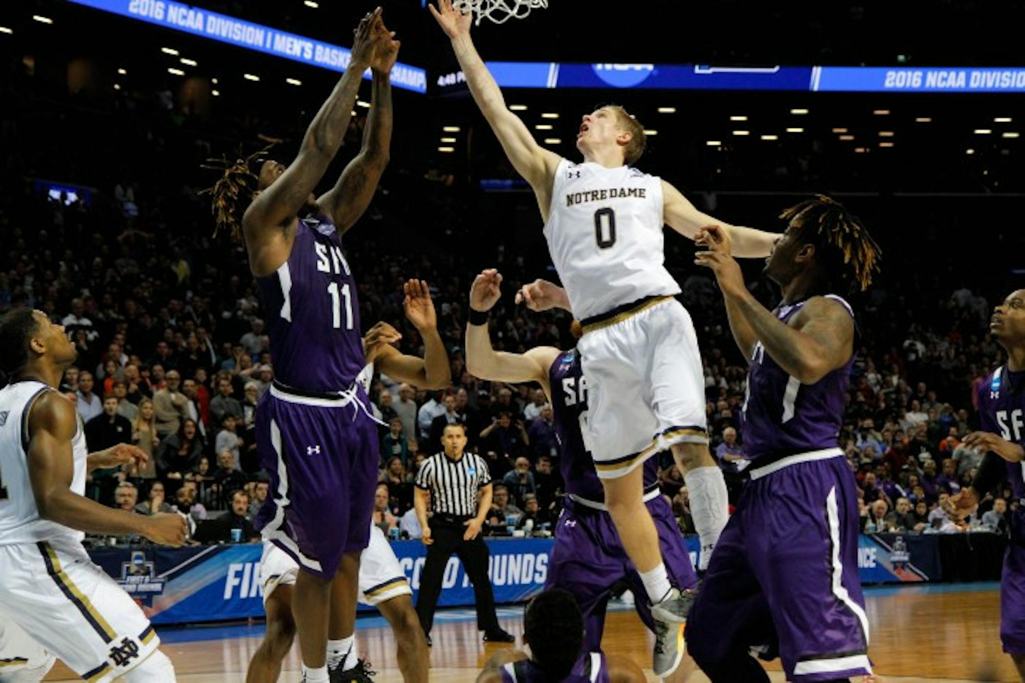 Freshman guard Rex Pflueger scores on a tip-in with 1.5 seconds left to lead Notre Dame past Stephen F. Austin, 76-75, at Barclays Center on Sunday.