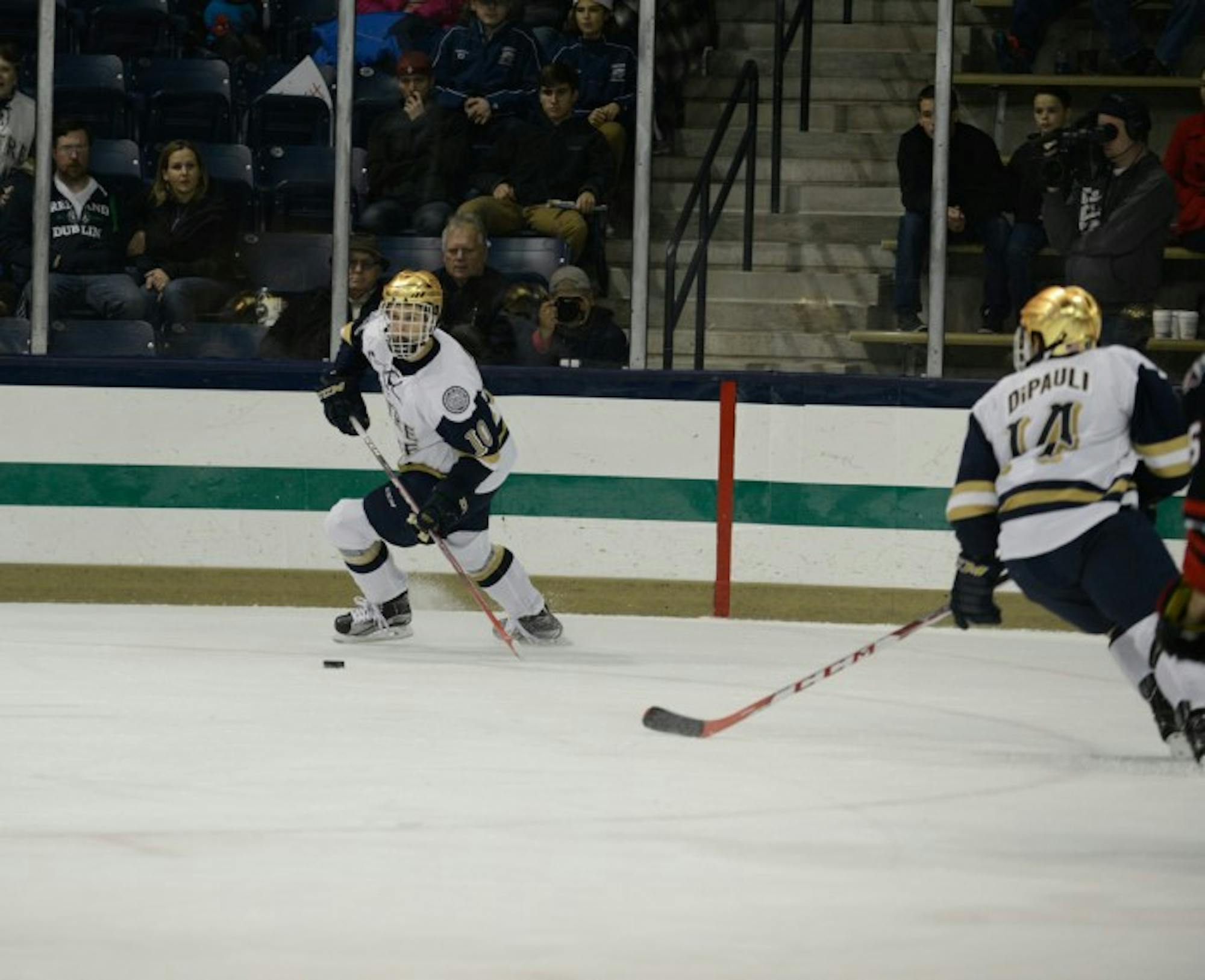 Irish sophomore left wing Anders Bjork looks to pass the puck during Notre Dame’s 3-2 win over Northeastern on Nov. 12.