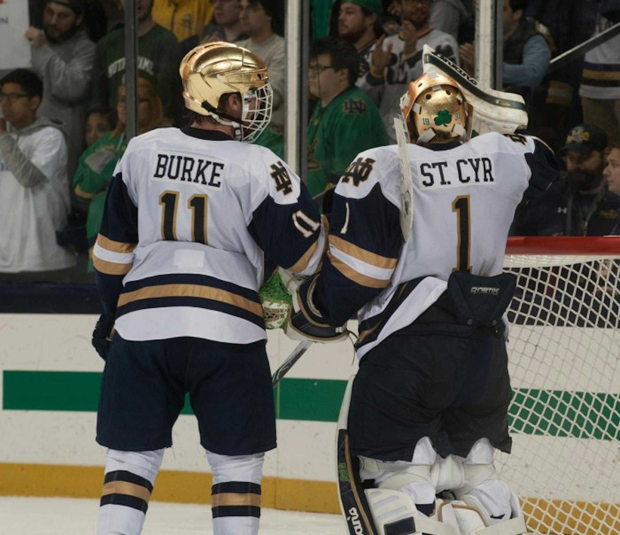 Irish sophomore forward Cal Burke and freshman goaltender Dylan St. Cyr talk during a break in the action during Notre Dame's 2-2 tie against Denver on Oct. 13 at Compton Family Ice Arena. St. Cyr finished with 46 saves on the night.