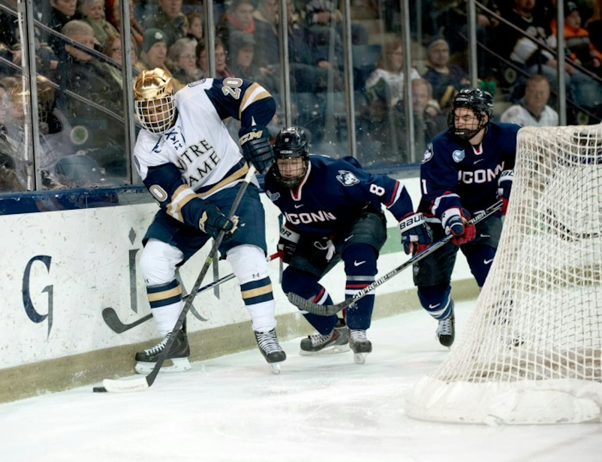 Notre Dame sophomore defenseman Justin Wade handles the puck during a 3-3 overtime tie with Connecticut in Compton Family Ice Arena.