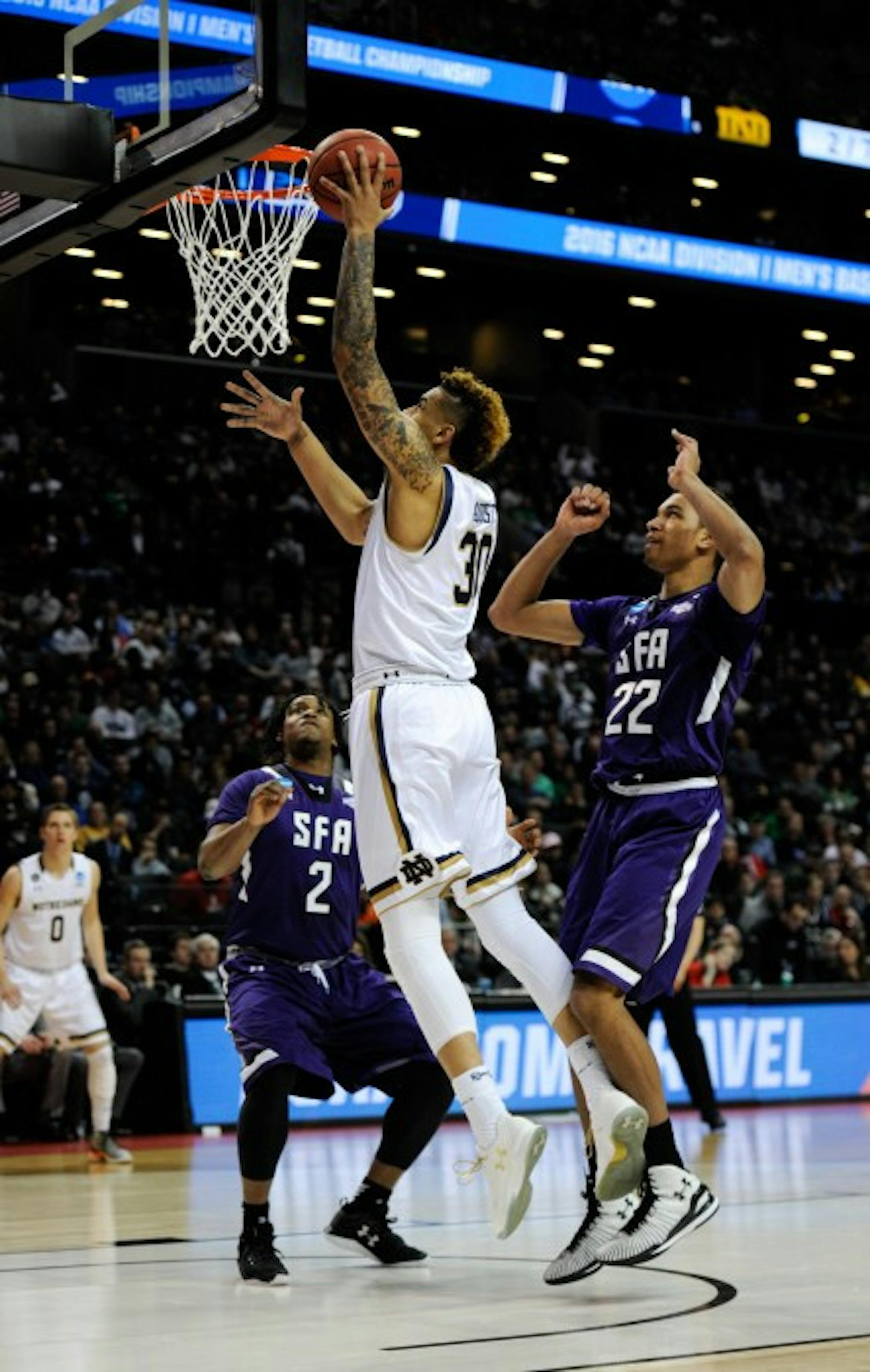 Irish senior forward Zach Auguste scores a layup during Notre Dame’s second-round win over Stephen F. Austin on Sunday in Brooklyn, N.Y.