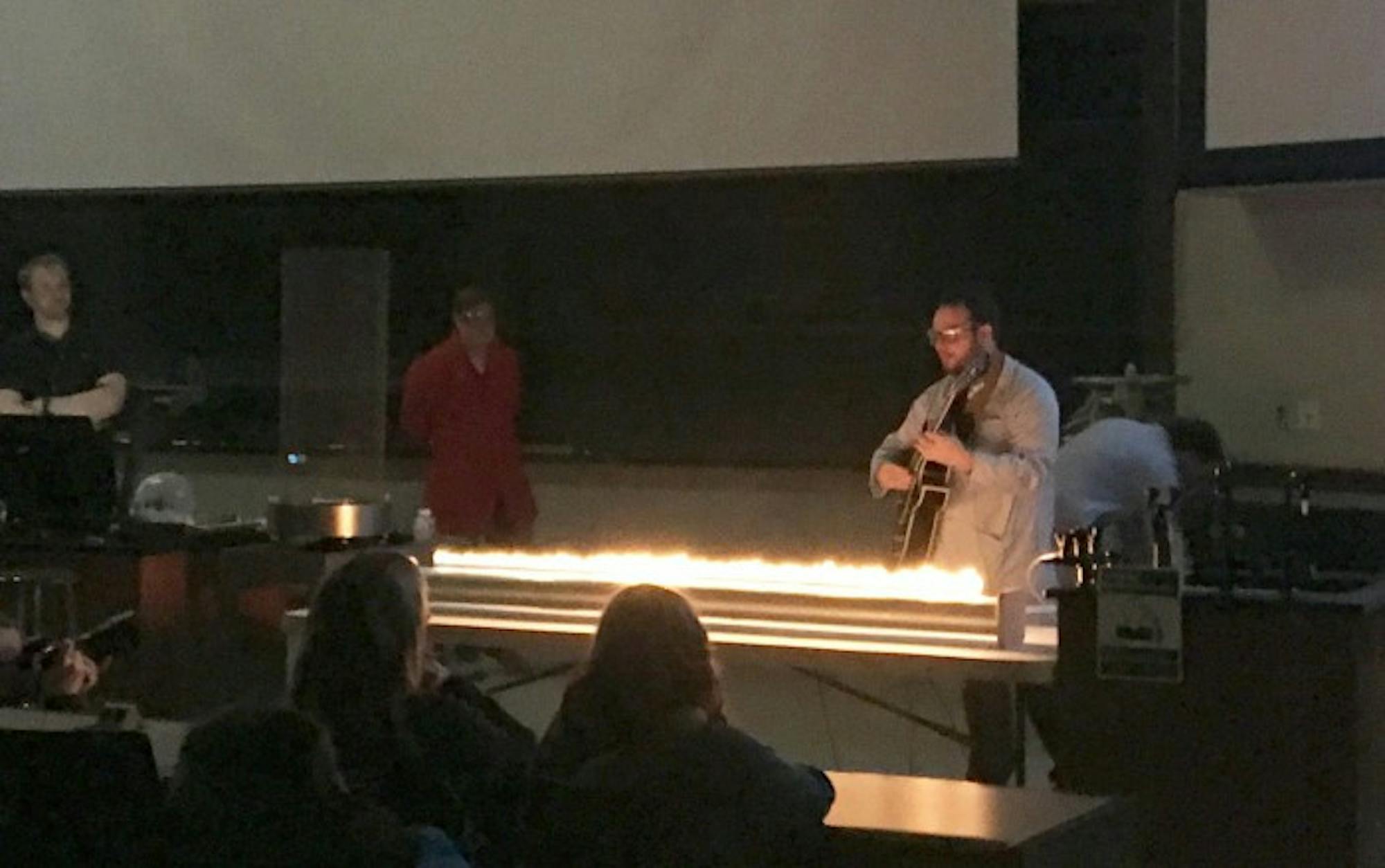 Graduate student Craig Reingold performs an experiment using an electric guitar and fire during Tuesday's