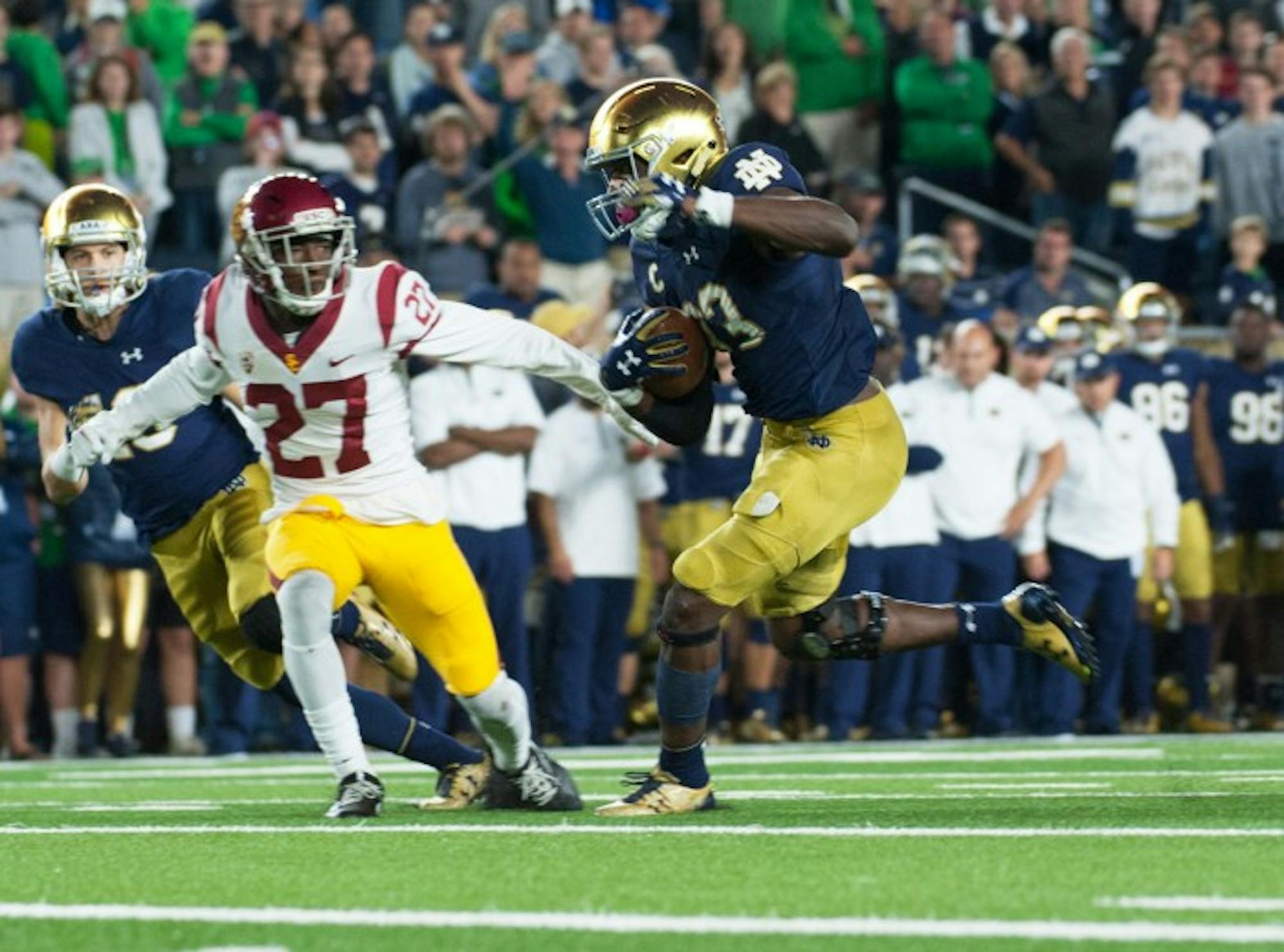 Irish junior running back Josh Adams rushes past a defender during Notre Dame’s 49-14 victory over  USC on Saturday at Notre Dame Stadium. Adams tallied 191 yards on 19 carries in the game.