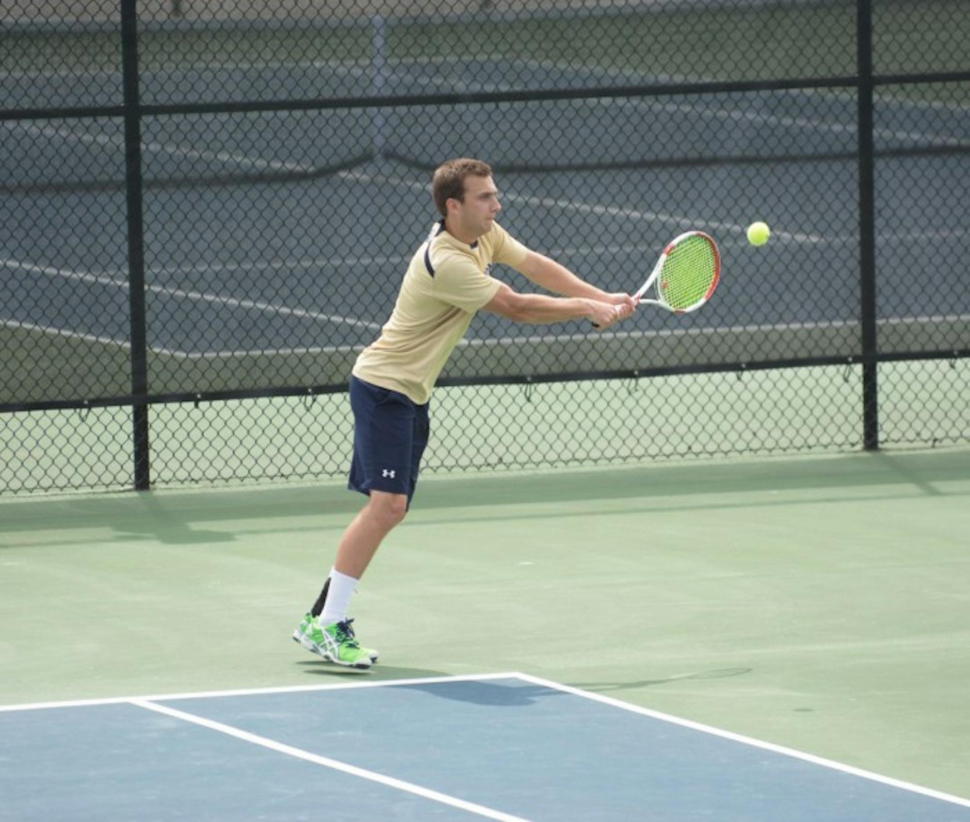 Junior Eddy Covalschi returns a shot during Notre Dame’s victory over Clemson on April 10 at Courtney Tennis Center. Covalschi lost his doubles match with junior Josh Hagar in Friday’s Irish loss.