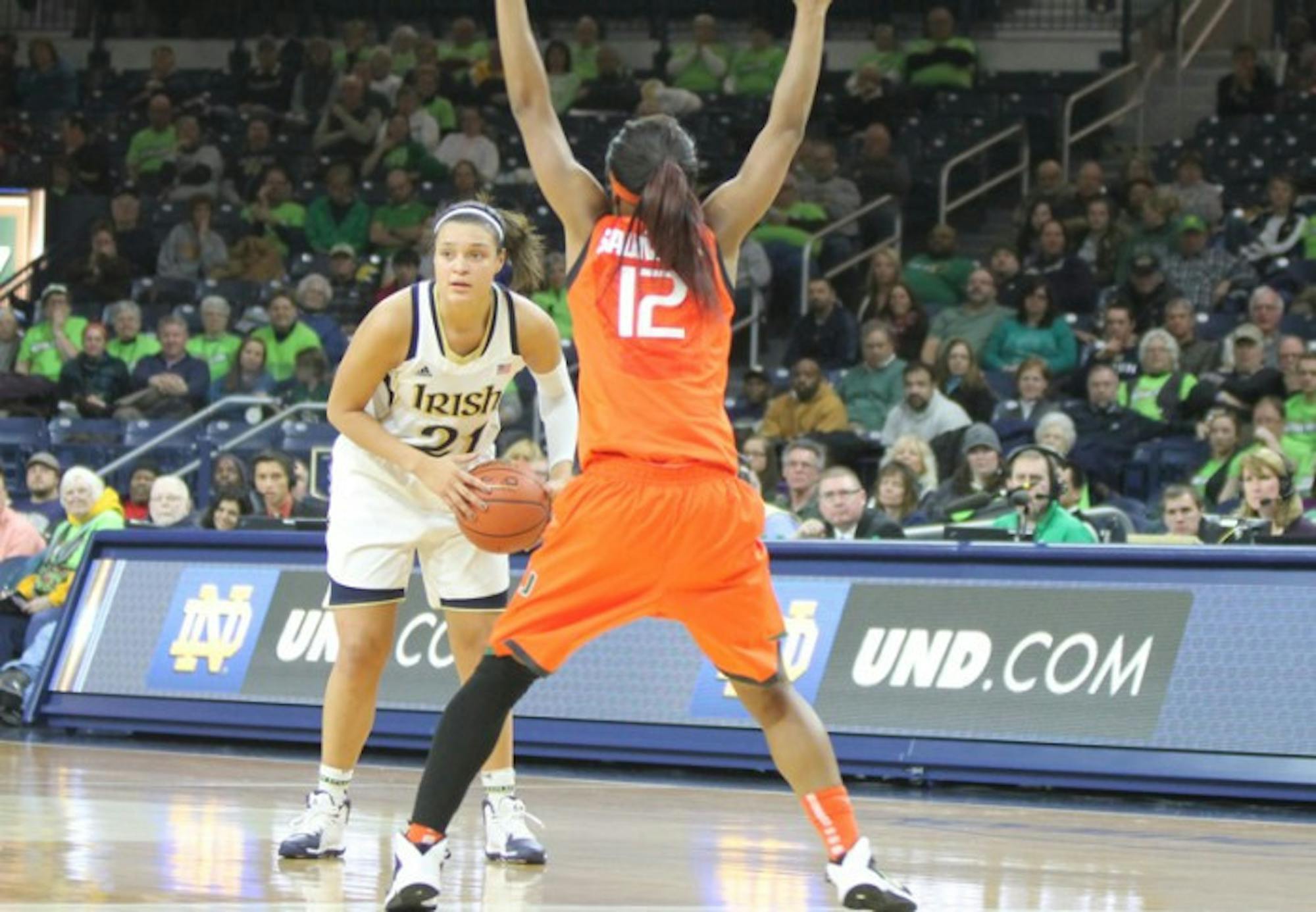 Senior forward Kayla McBride looks for a pass while defended by Miami senior guard Krystal Saunders on Jan. 23. McBride picked up a double-double with 23 points and 11 rebounds against Duke on Sunday.