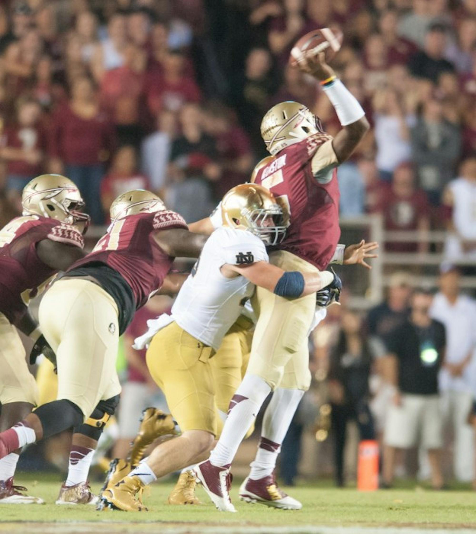 Senior Joe Schmidt gets a hit on Seminole sophomore quarterback Jameis Winston during Notre Dame's 31-27 loss against Florida State University on Oct. 18 at the Doak Cambell Stadium.