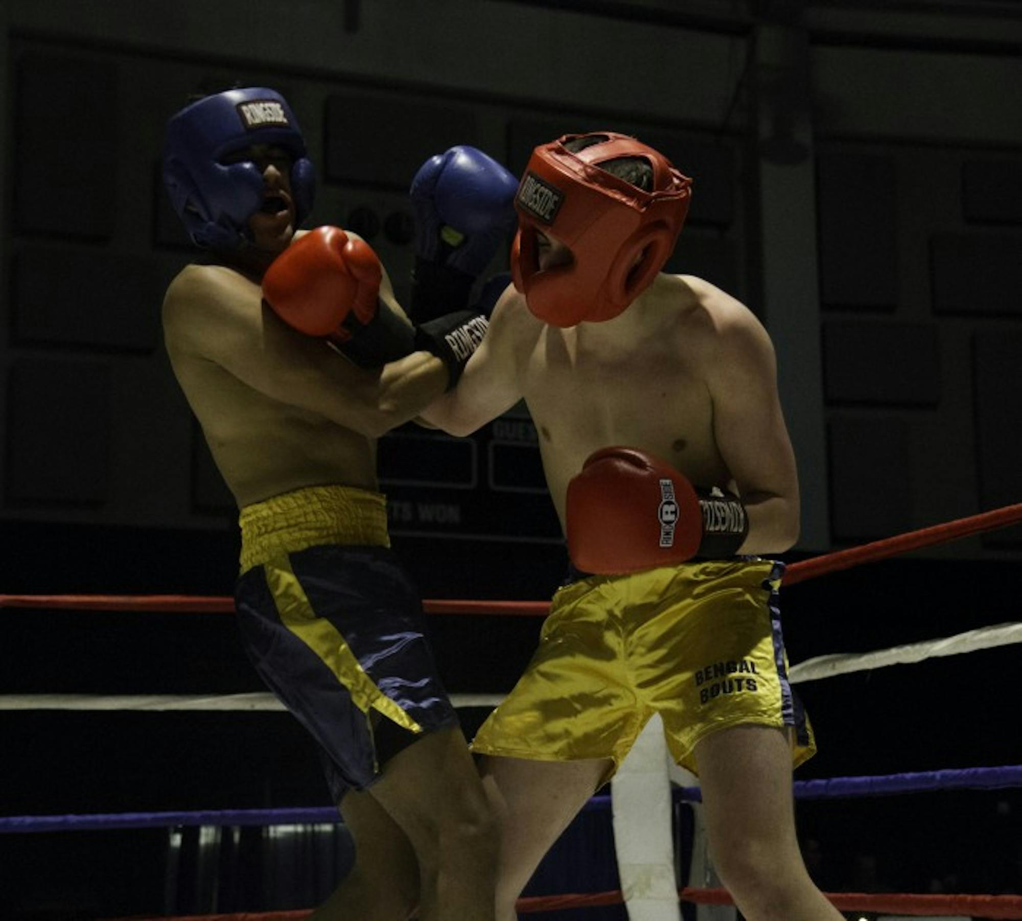 Junior Conor Ward, right, tangles with his opponent, sophomore Alfred Duarte, in the preliminary round of the 146-pound division in the 87th annual Bengal Bouts tournament. Ward went on to win the fight.