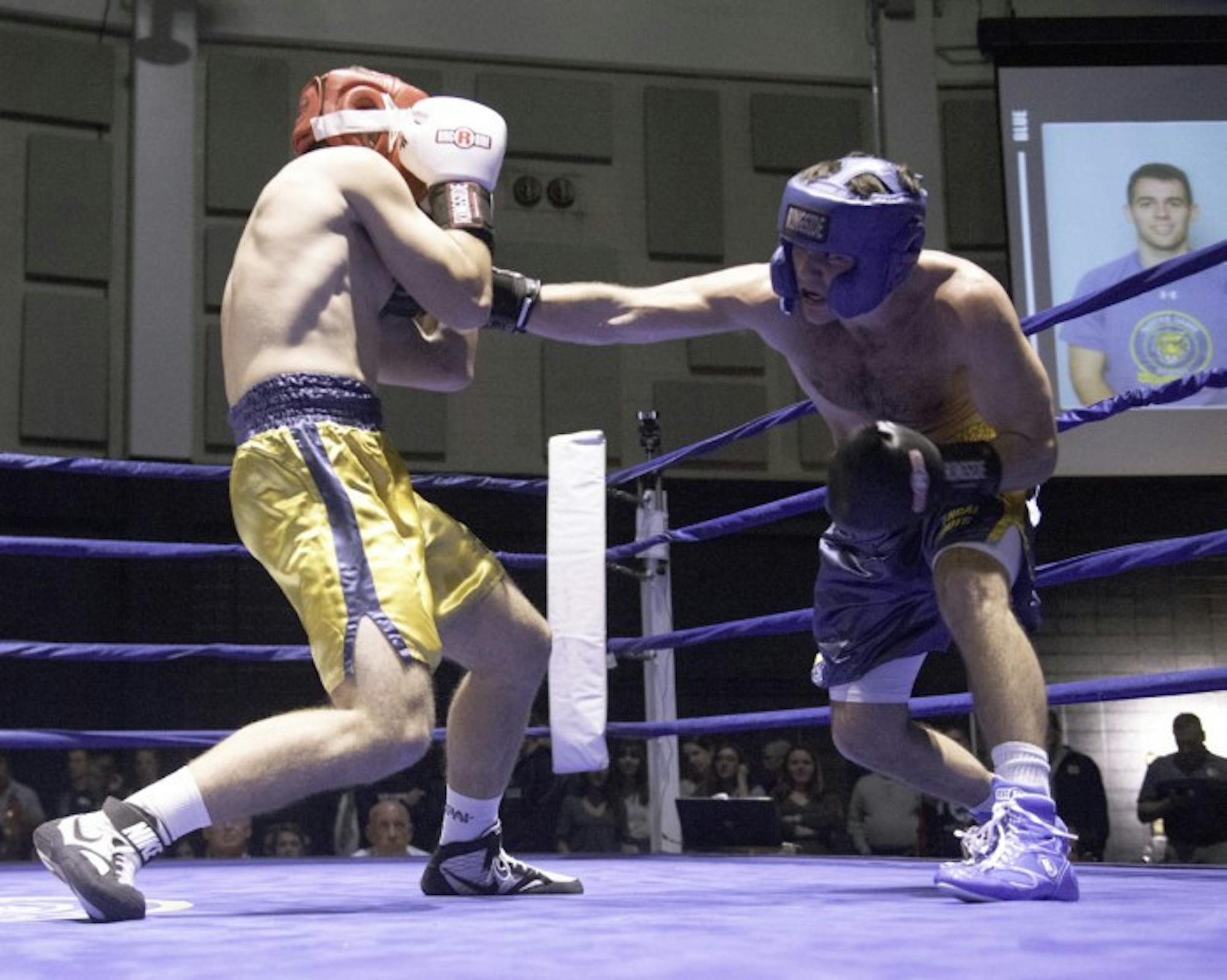 Senior captain Jack Corrigan lands a right jab to the chest of sophomore Michael Krecek during a 174-pound semifinal bout Monday at the Joyce Center Fieldhouse. Highlights of Corrigan’s four-year Bengal Bouts career include helping break the fundraising goal in 2016 and traveling to Bengladesh to witness the Holy Cross missions.
