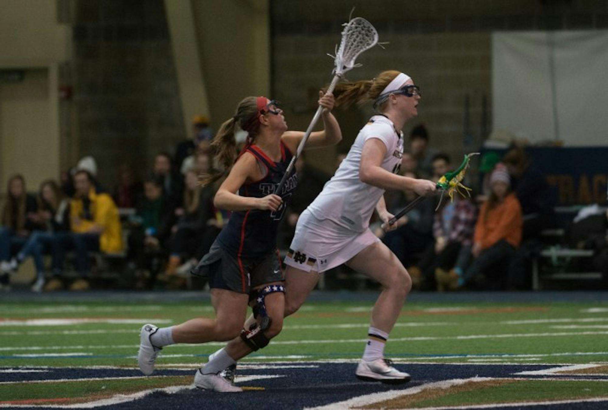 Junior midfielder Brie Custis races forward for the ball against  Detroit on Feb.15. Custis and the Irish sprinted past the Titans, 17-5, in their home opener.