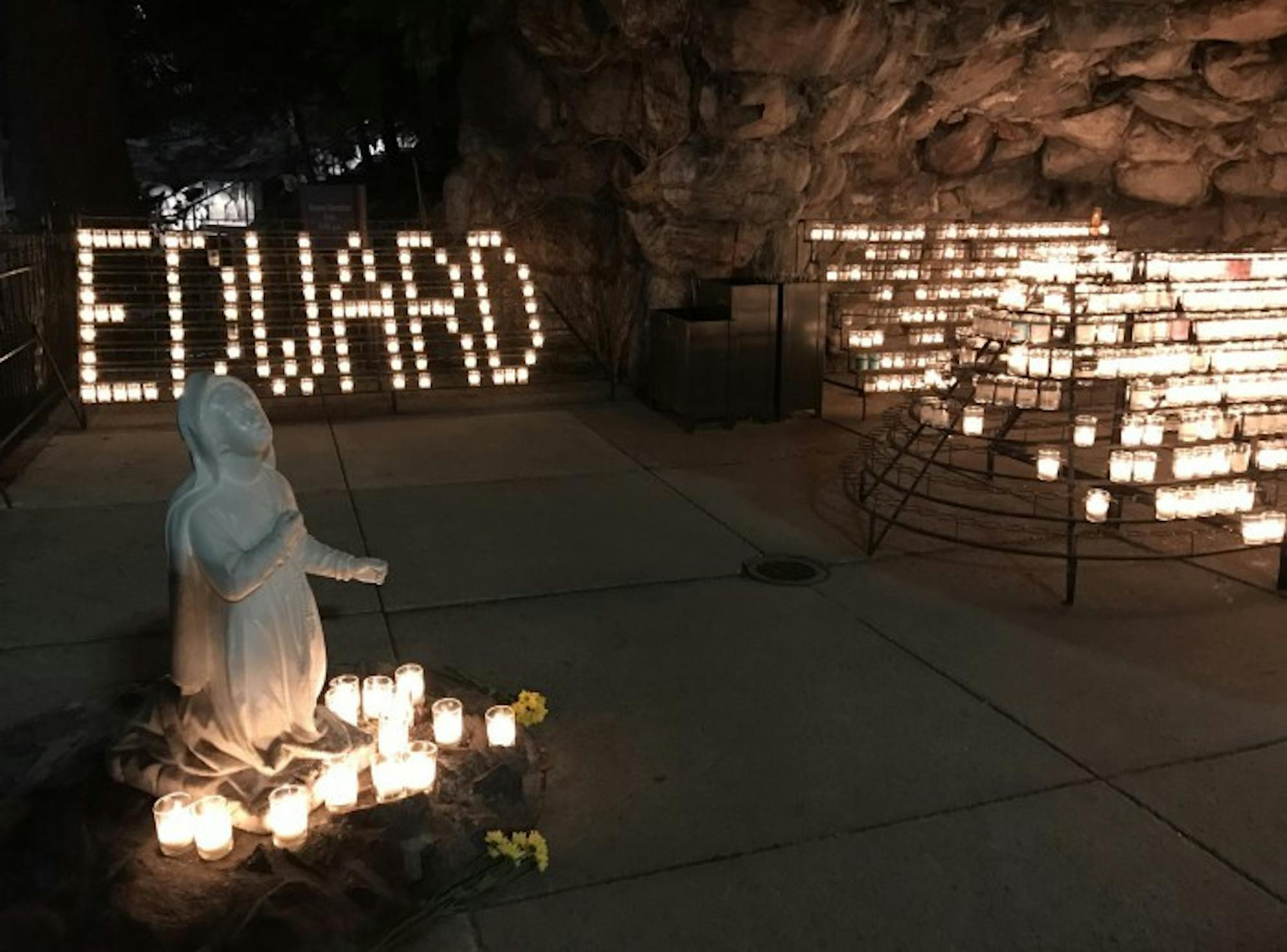 Edward Lim's name is written out in candles at the grotto Wednesday. Lim, a former Notre Dame student, passed away Friday.