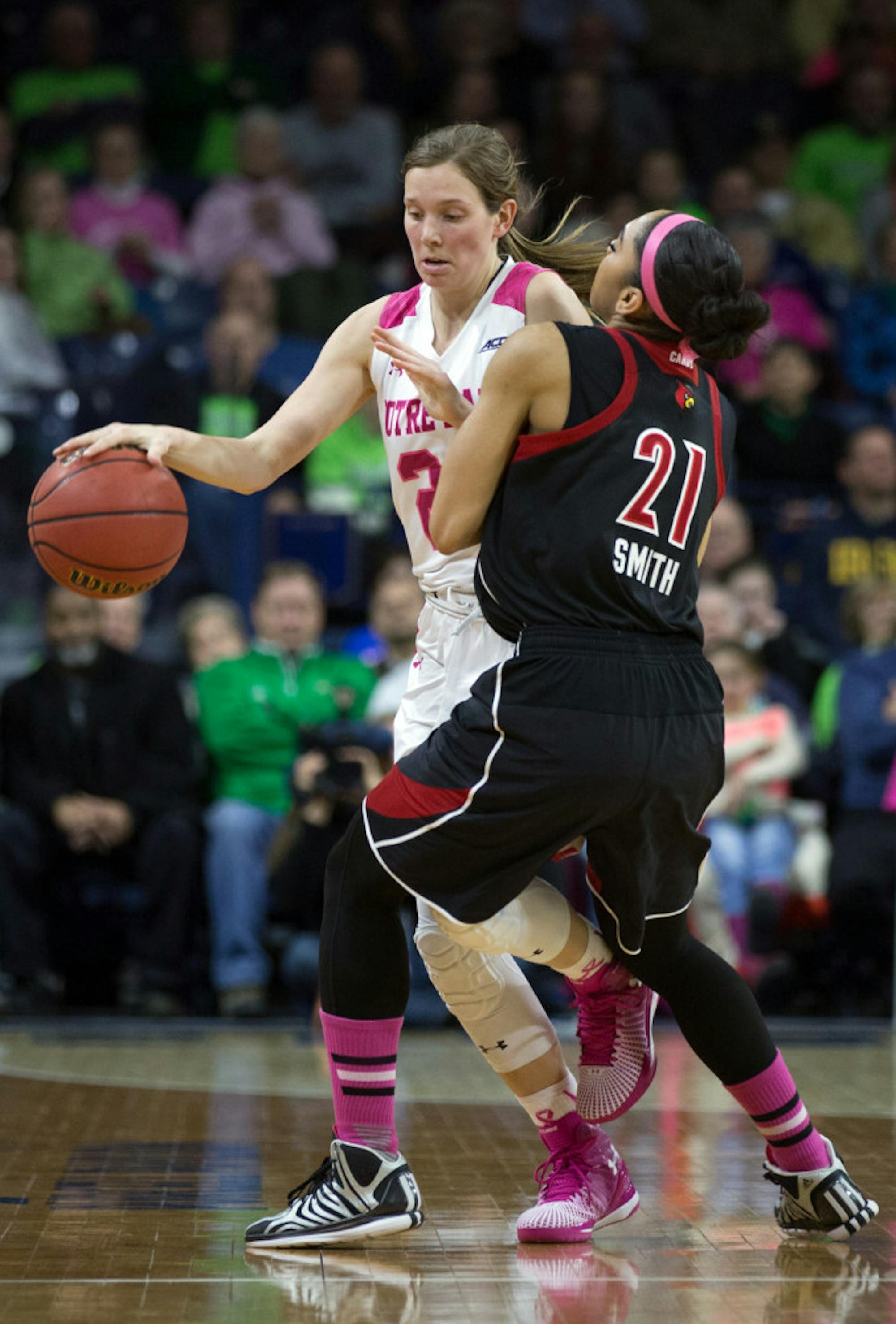 Irish senior guard Madison Cable tries to dribble around a Louisville defender in the Notre Dame win Monday.