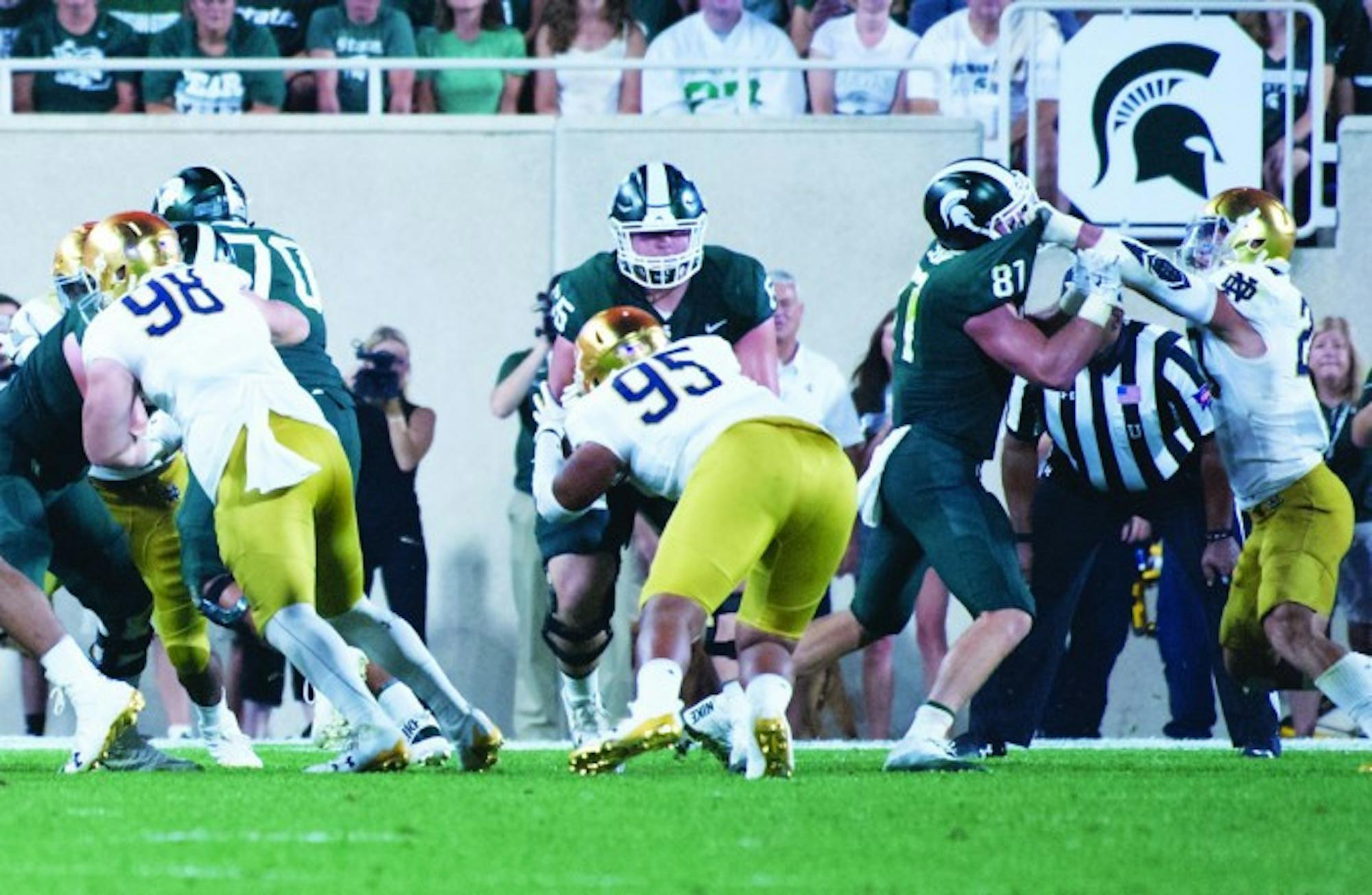 Irish freshman defensive line Myron Tagovailoa-Amosa tackles an opponent during Notre Dame's 38-18 win over Michigan State on Saturday in East Lansing, Michigan.