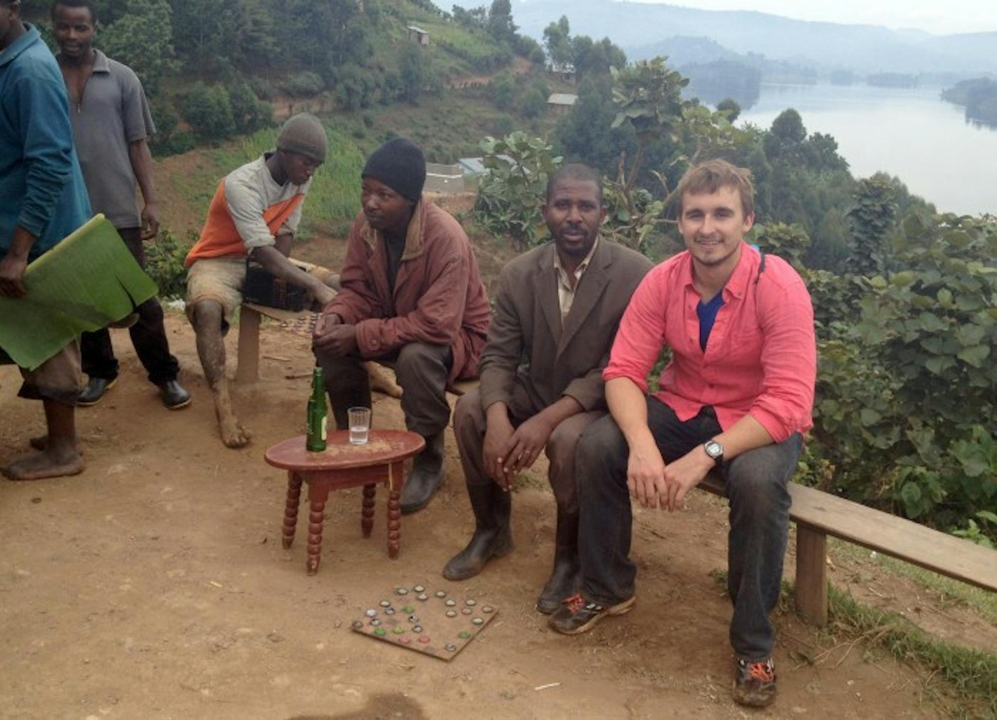 Senior Graham Englert poses with community members around Lake Bunyonyi outside Kabale in southwest Uganda. Englert studied the effects of disease outbreaks on healthcare workers in the region this summer.
