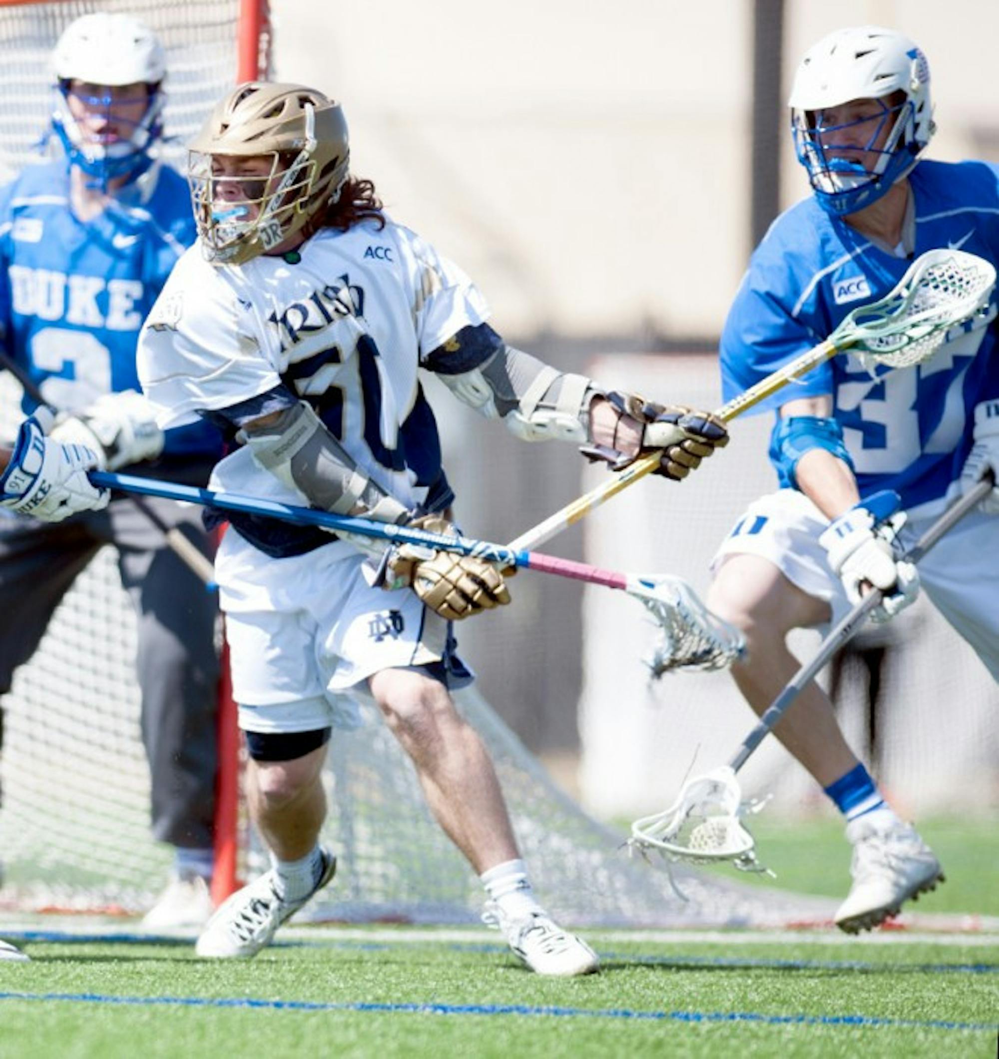 Sophomore attack Matt Kavanagh attempts to break through two Duke defenders in the 15-7 Irish loss April 5. The game was one of only two this season in which Kavanagh did not score a point.