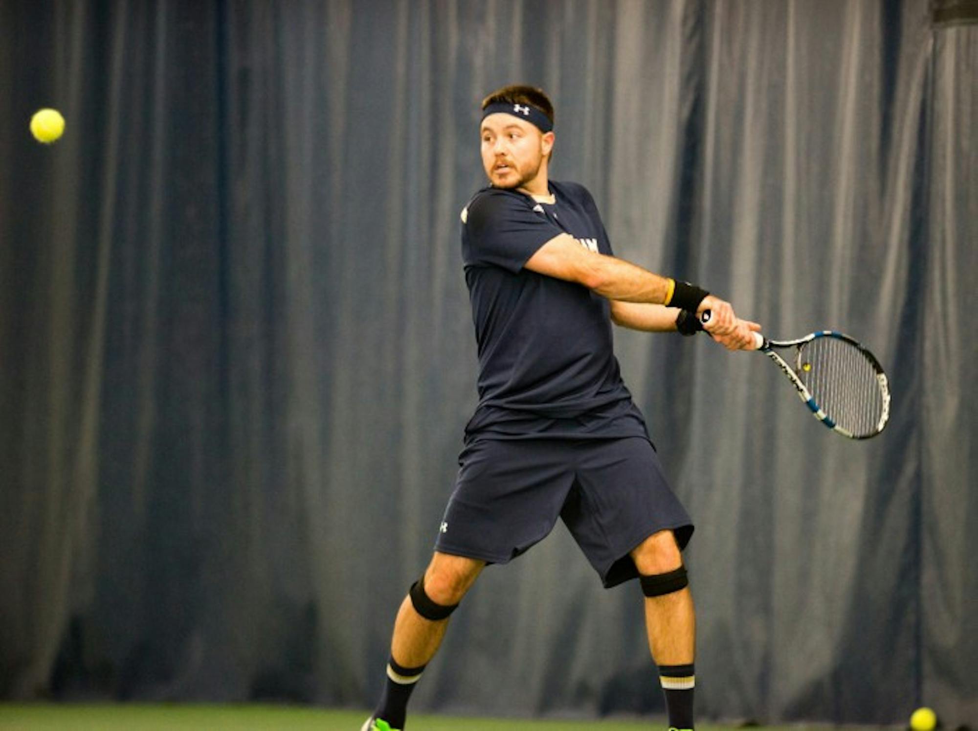 Senior Billy Pecor hits a backhand during Notre Dame's 4-3 win over Oklahoma State on Jan. 24 at Eck Tennis Pavilion.