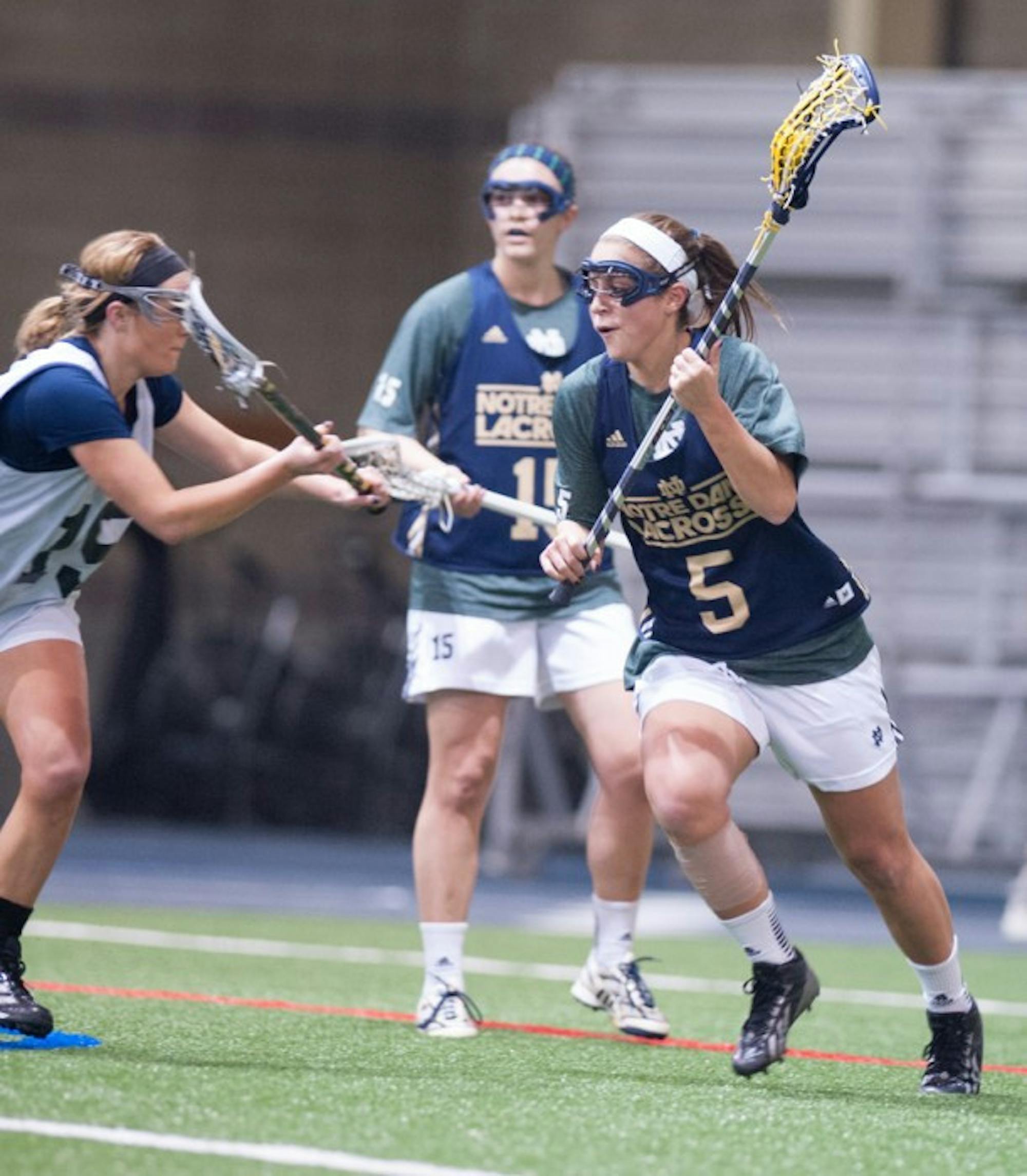 Irish sophomore attacker Rachel Sexton, 5, carries the ball during Notre Dame’s 19-7 home win over Michigan in exhibition play Feb. 8.