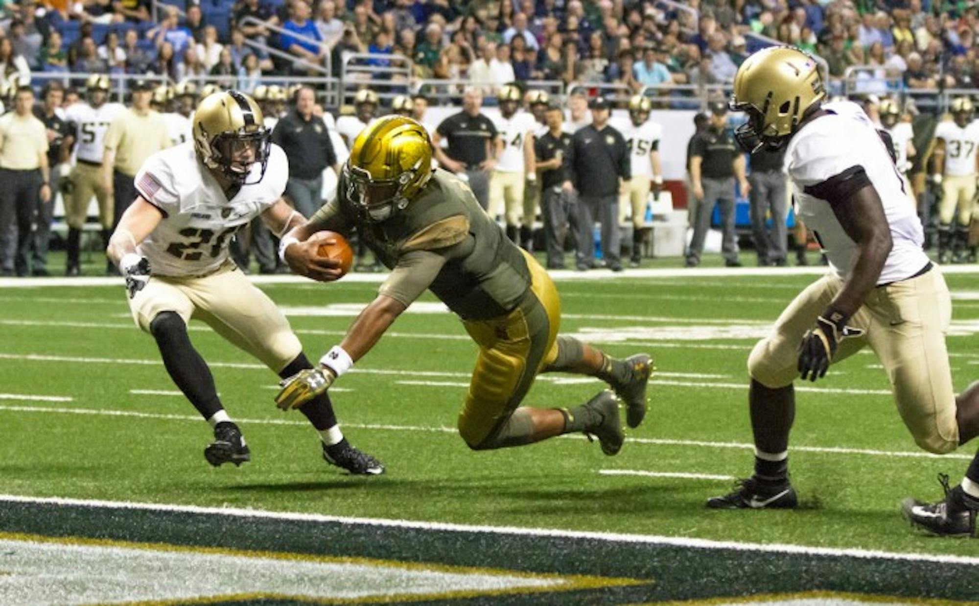 Irish junior quarterback DeShone Kizer dives into the end zone during Notre Dame's 44-6 win in San Antonio on Saturday.
