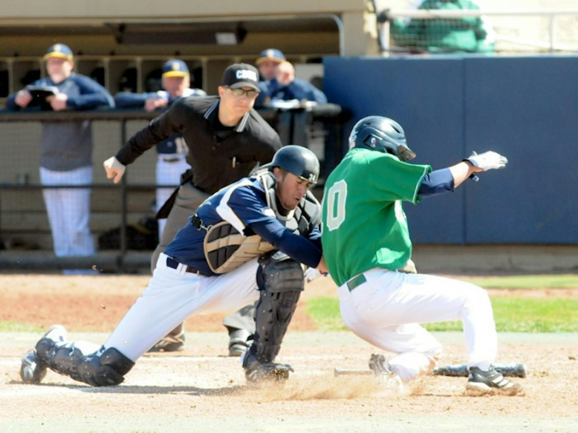 Irish junior Conor Biggio attempts to avoid the tag at the plate against Quinnipac on April 21, 2013, when Notre Dame claimed a 5-1 victory. This season, Biggio shares the team lead with seven stolen bases.