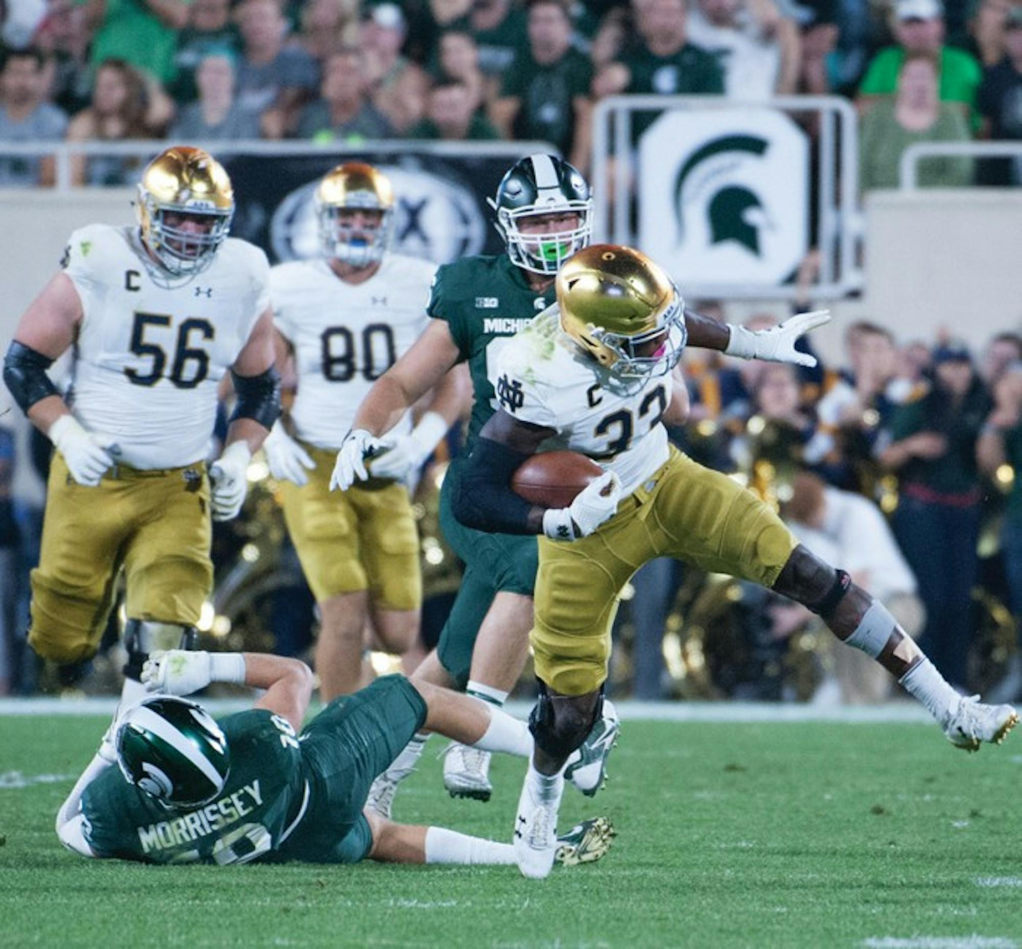 Junior Irish running back Josh Adams tries to keep his balance after breaking a tackle during Notre Dame's 38-18 win over Michigan State on Sept. 23.