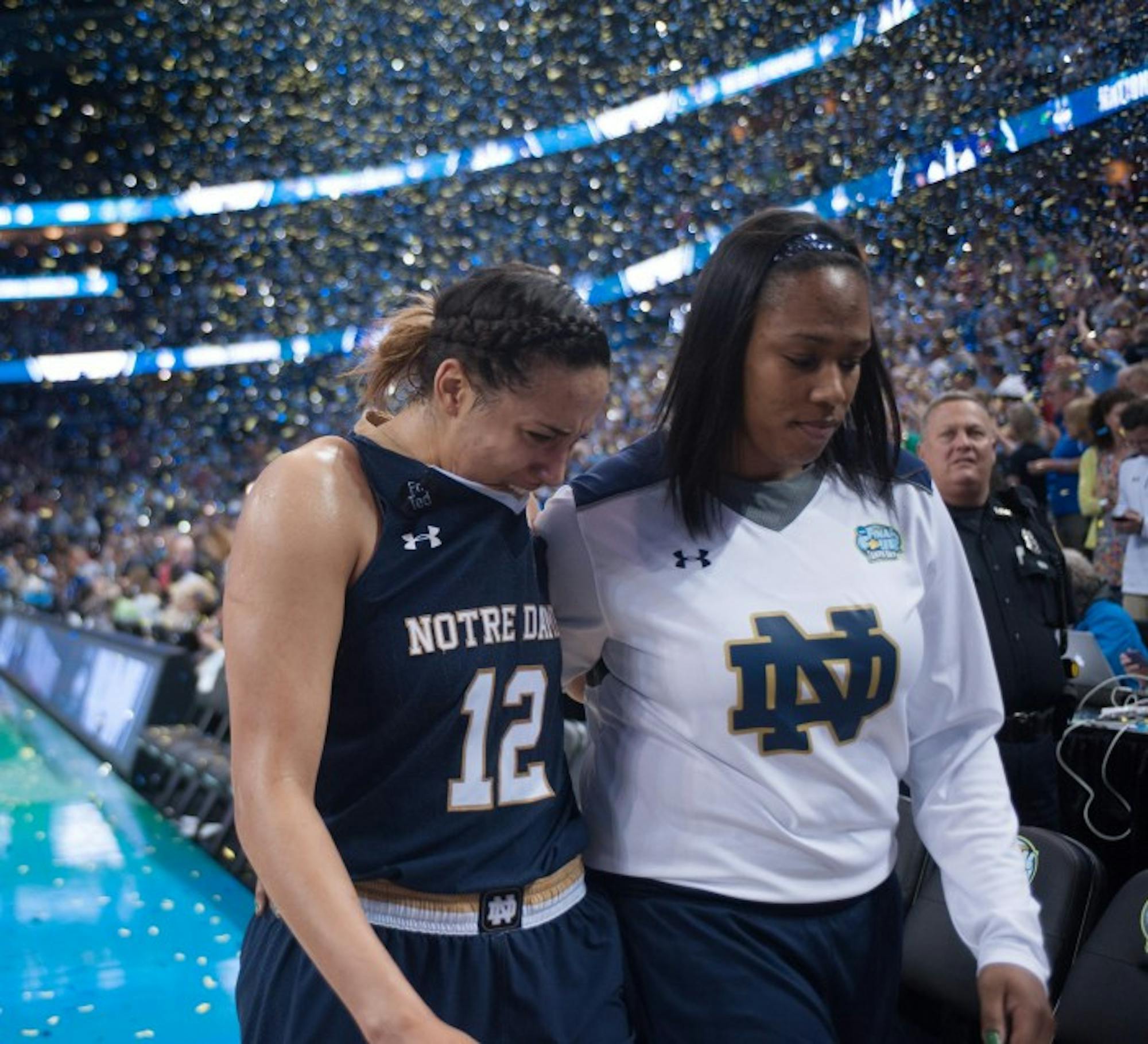 Sophomore forward Taya Reimer (left) walks off the court with sophomore forward Kristina Nelson following the 63-53 defeat of the Irish by Connecticut on Tuesday.