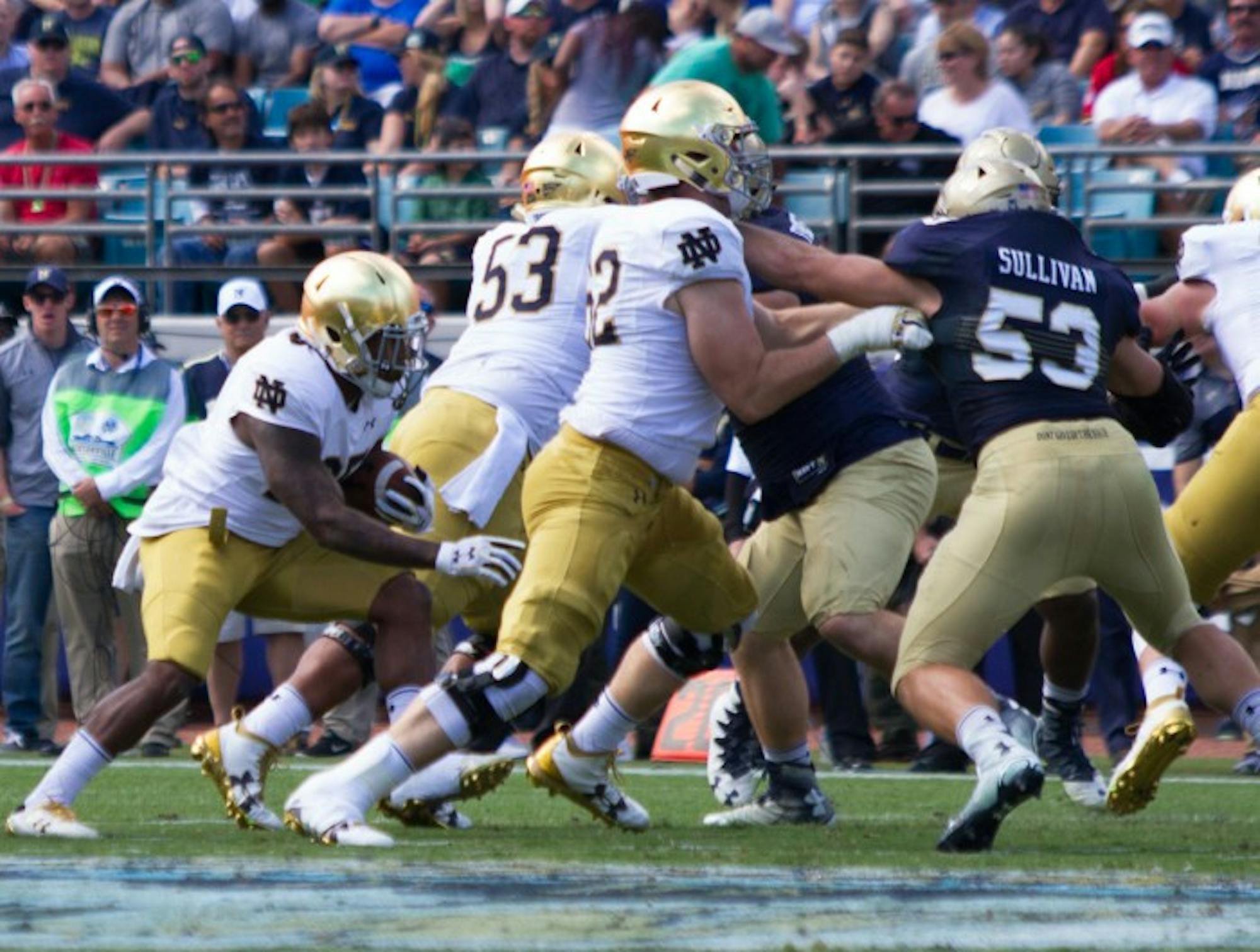 Irish senior offensive lineman Colin McGovern, front, engages a Navy defender during Notre Dame’s loss to the Midshipmen on Nov. 5.
