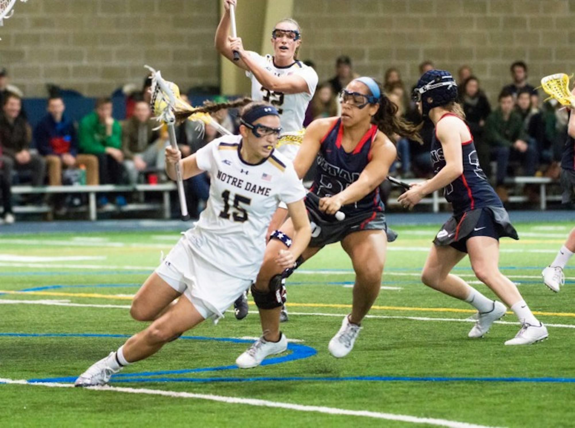 Irish sophomore attack Cortney Fortunato spins away from a  defender during Notre Dame’s 17-5 win over Detroit on Sunday.