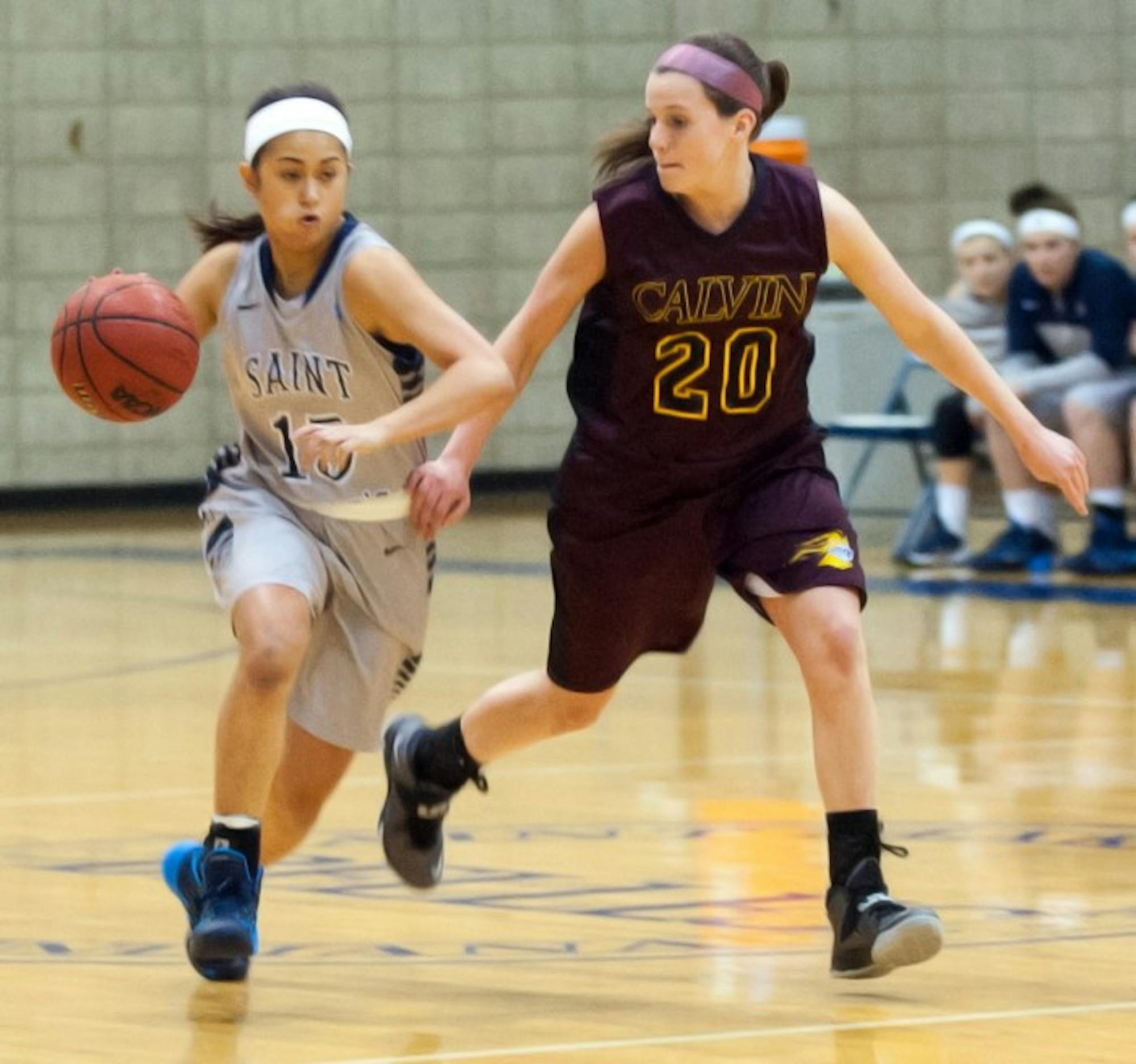 Belles sophomore guard Heather Pesigan brings the ball up the court during a 95-68 loss to Calvin on Jan. 15.