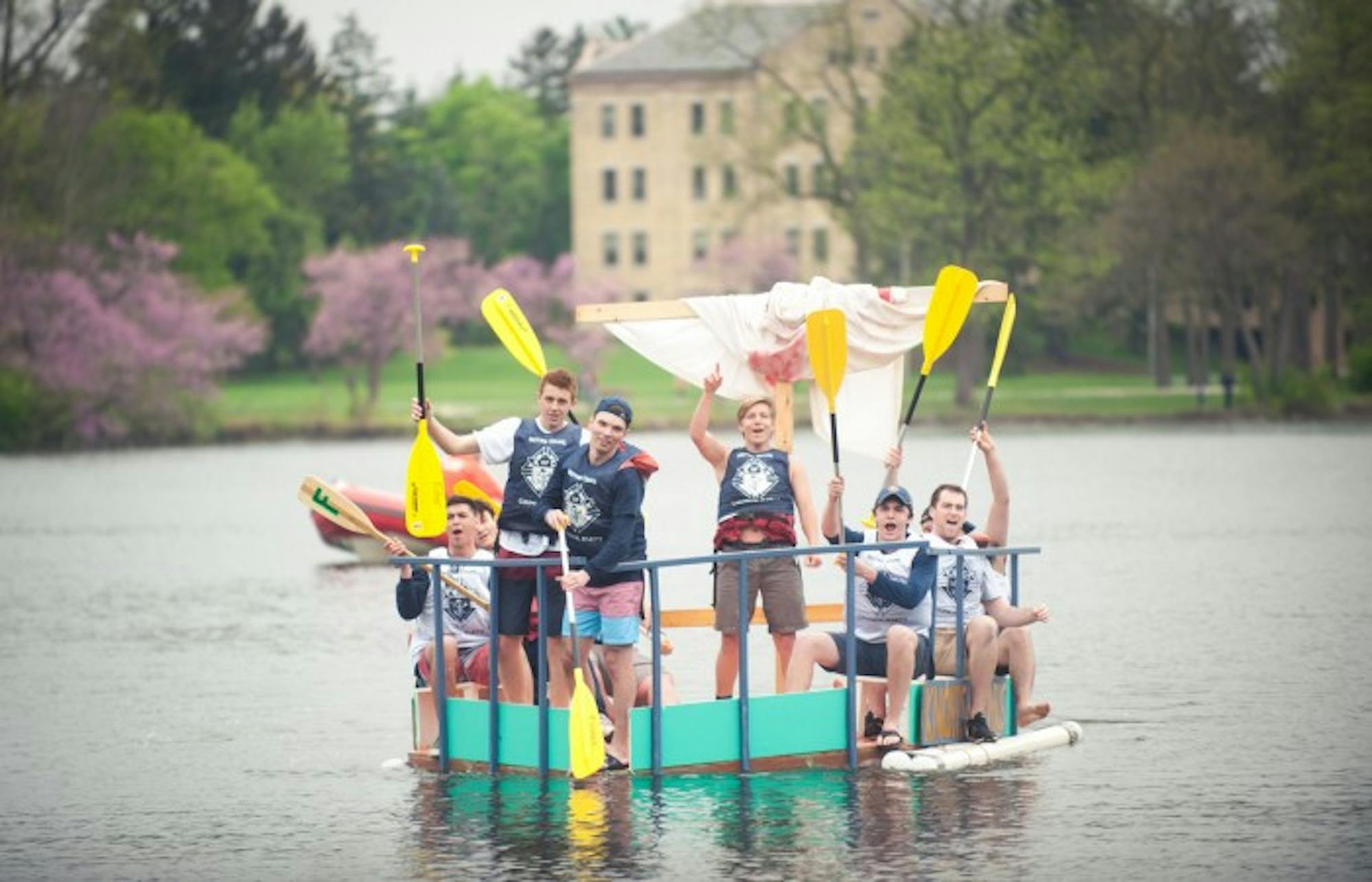 Participants travel across St. Mary's Lake during Saturday's event. A team of freshmen from Fisher Hall won this year's Fisher Regatta with their boat