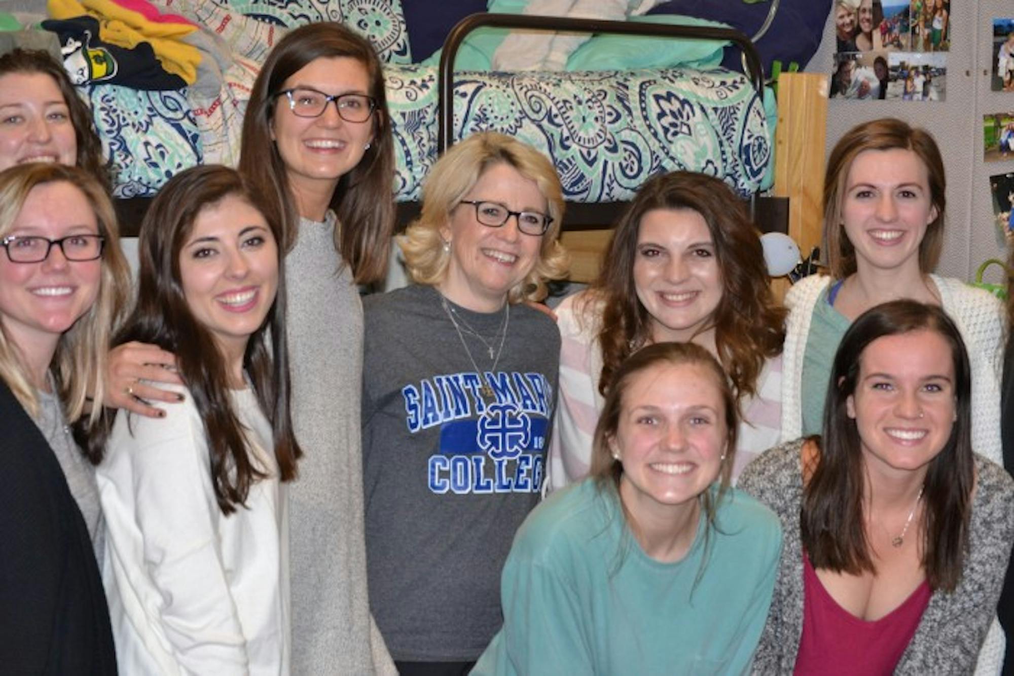 Students pose with Saint Mary's President Jan Cervelli in Le Mans Hall on Thursday night. Cervelli spent the night in a dorm room with three students to gain a better understanding of what residential life is like for students at the College.