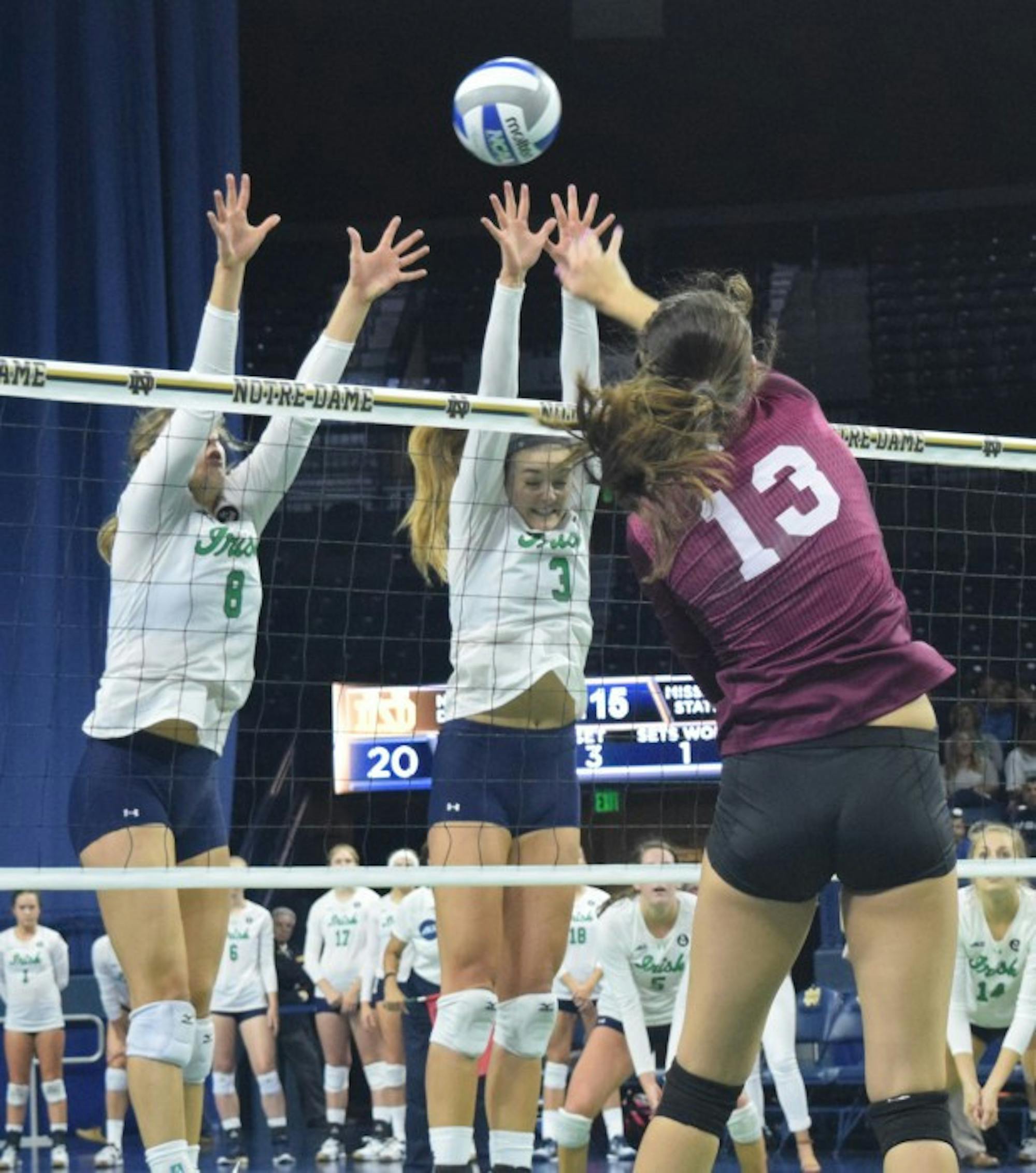 Sophomore outside hitter Sam Fry (right) and sophomore setter Maddie Dilfer go up for a block during  a 3-1 victory against Mississippi State on Sept. 11 at Purcell Pavilion.