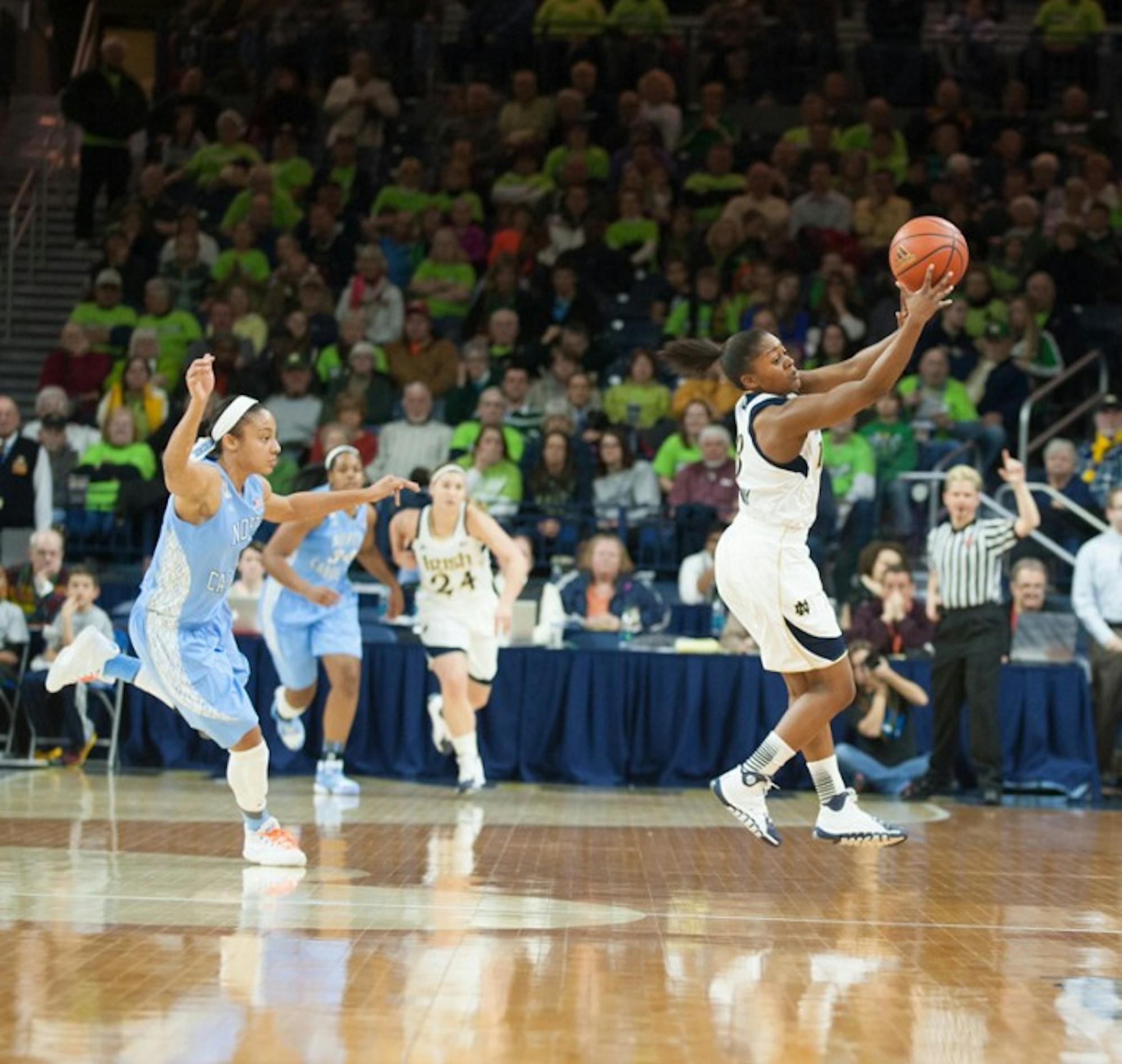 Junior guard Whitney Holloway attempts to gain control of the ball during Notre Dame’s 100-75 home win over UNC on Thursday.