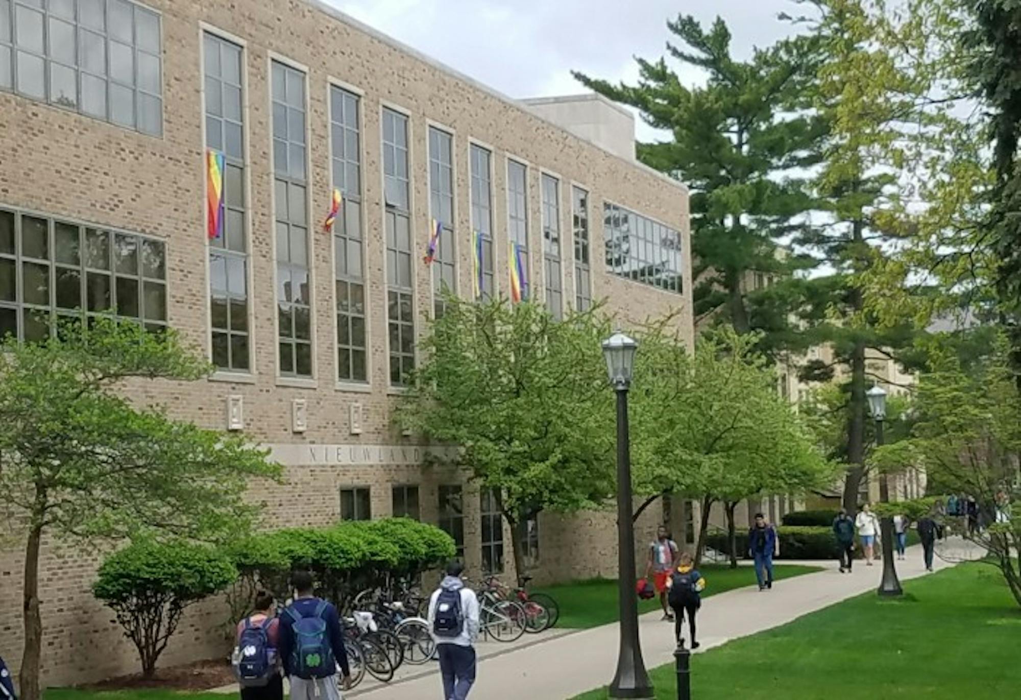 Pride flags hang from the windows of Nieuwland Hall. The flags, distributed by student groups, are being displayed as a sign of protest against this year's Commencement speaker, Vice President Mike Pence.
