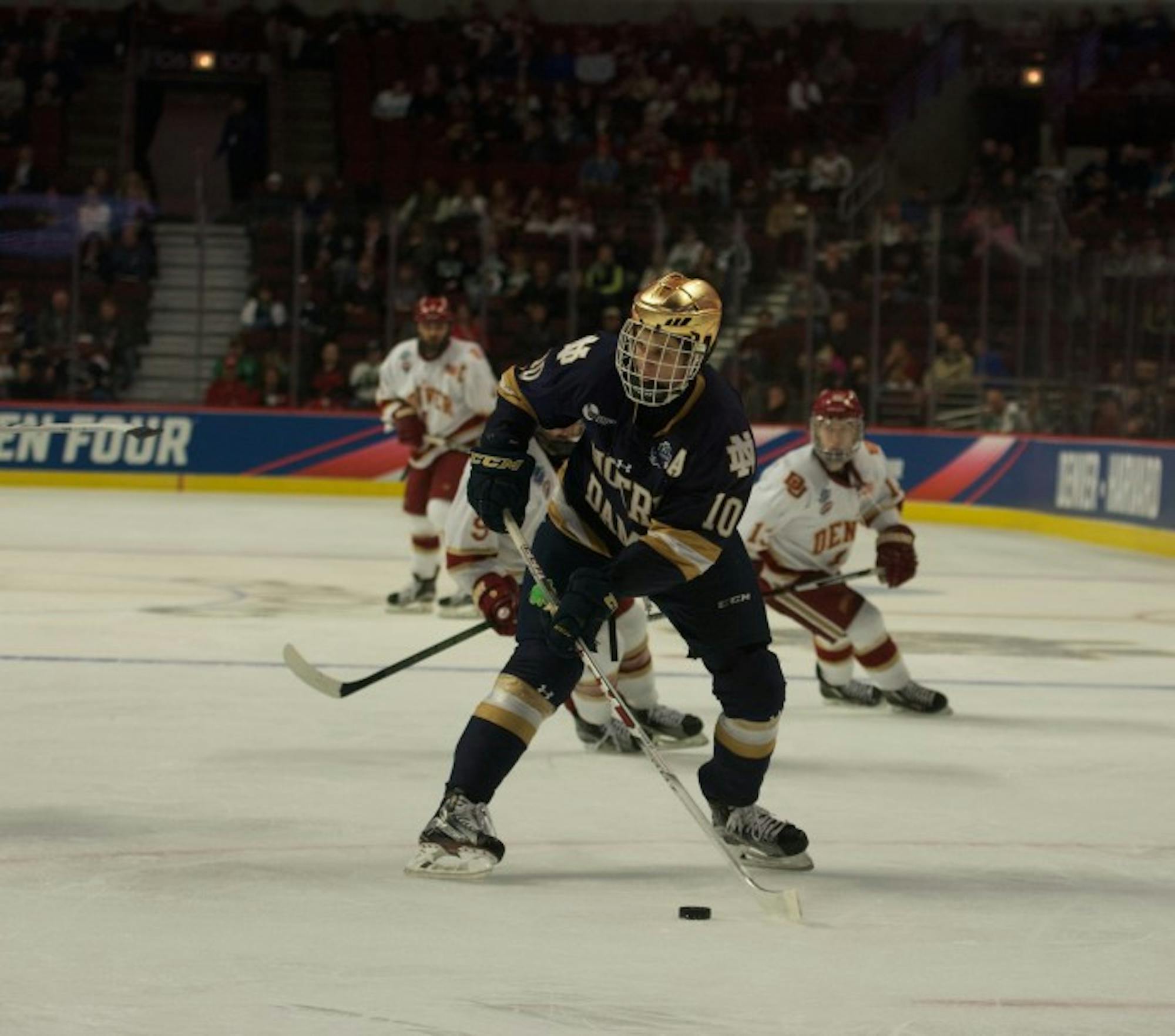Irish junior forward Anders Bjork looks to move the puck during Notre Dame’s 6-1 loss to Denver in the Frozen Four on April 6 at United Center. Bjork scored 109 points for the Irish during his career.