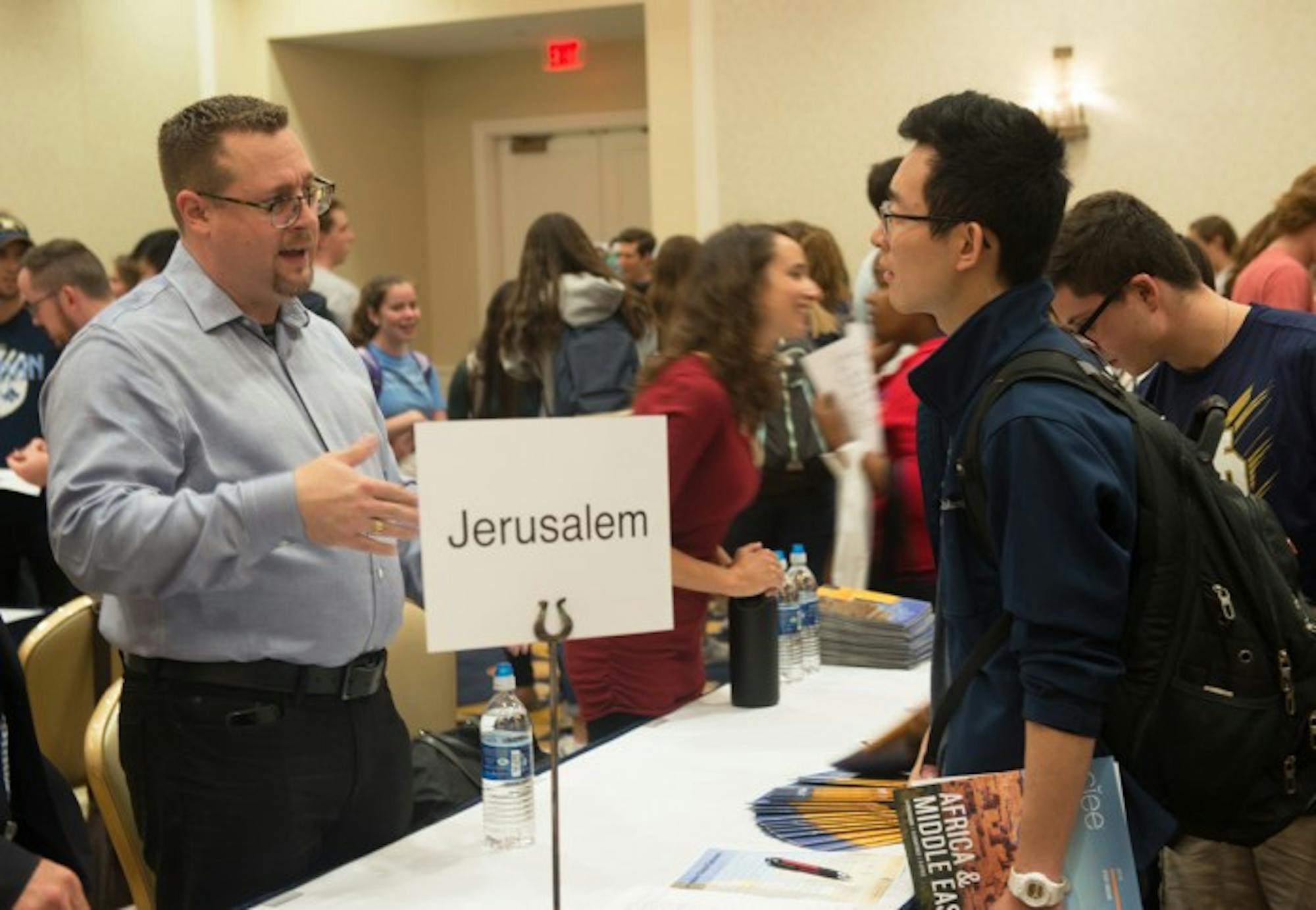 A student speaks with a program representative at the Study Abroad Fair. The event, held in the Morris Inn Ballroom, aims to introduce students to various different study abroad programs.