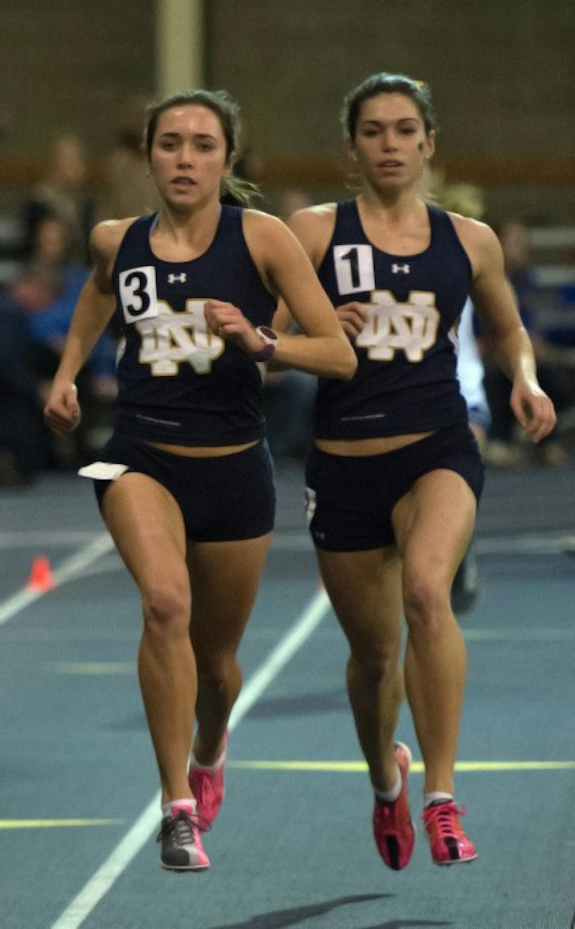 Irish junior Danielle Aragon, left, and freshman Jessica Harris race side-by-side during the 1,000-meter run Friday.