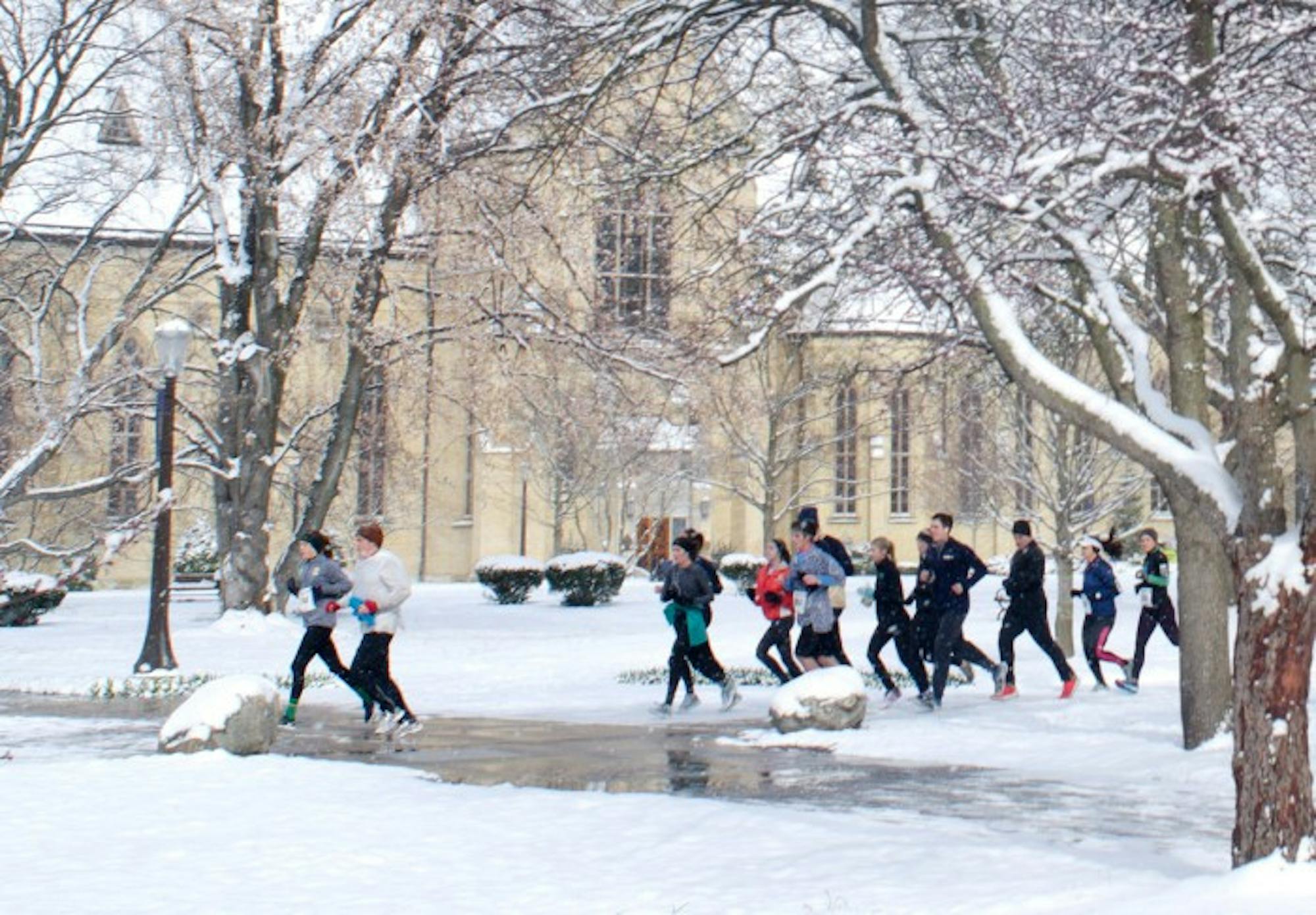 Students and community members run through campus after the Holy Half Marathon was cancelled due to unforeseen icy conditions.