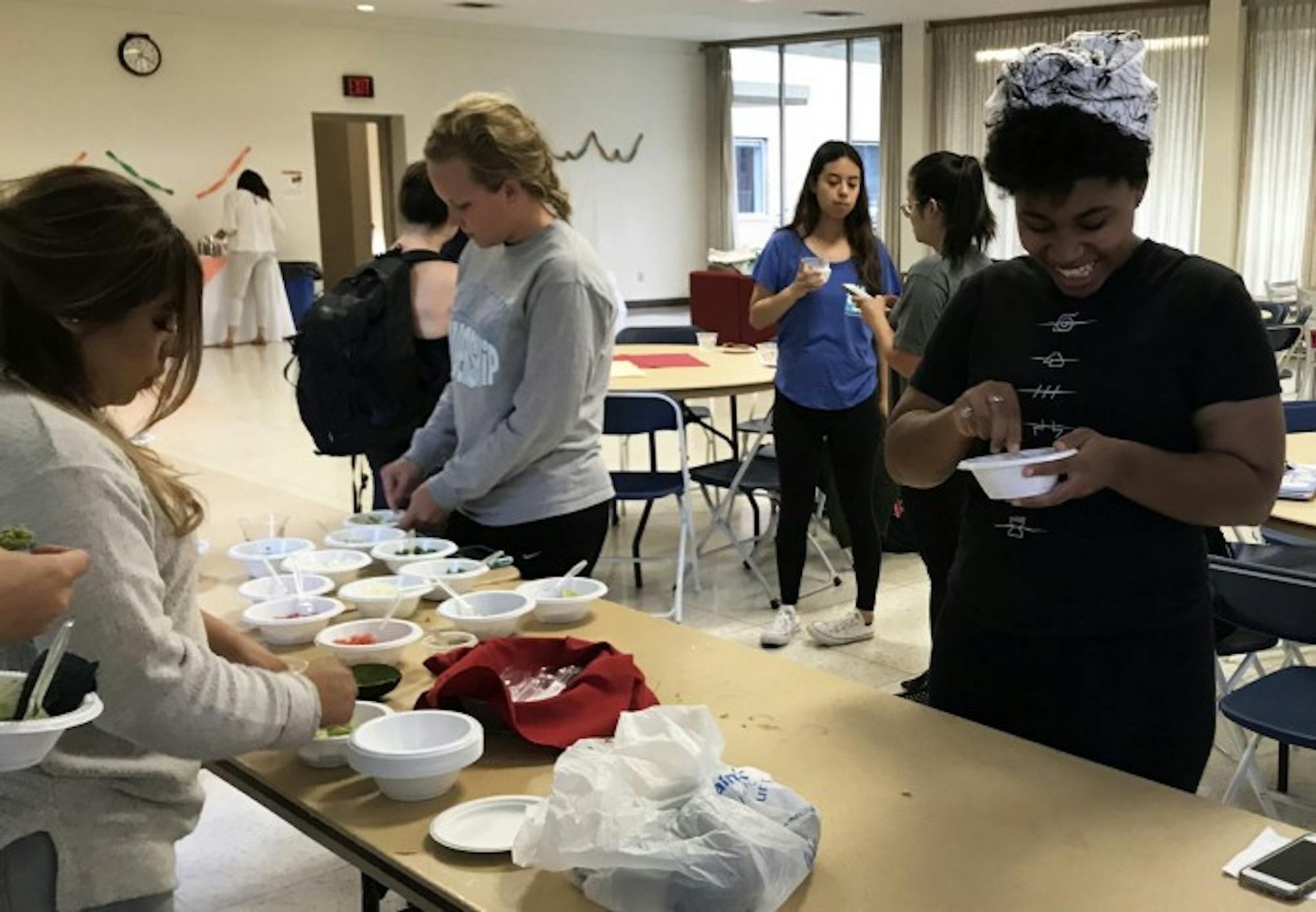 Students participate in the guacamole making contest at an event, hosted by Saint Mary's Latina culture club, La Fuerza, marking the beginning of Hispanic Heritage Month.